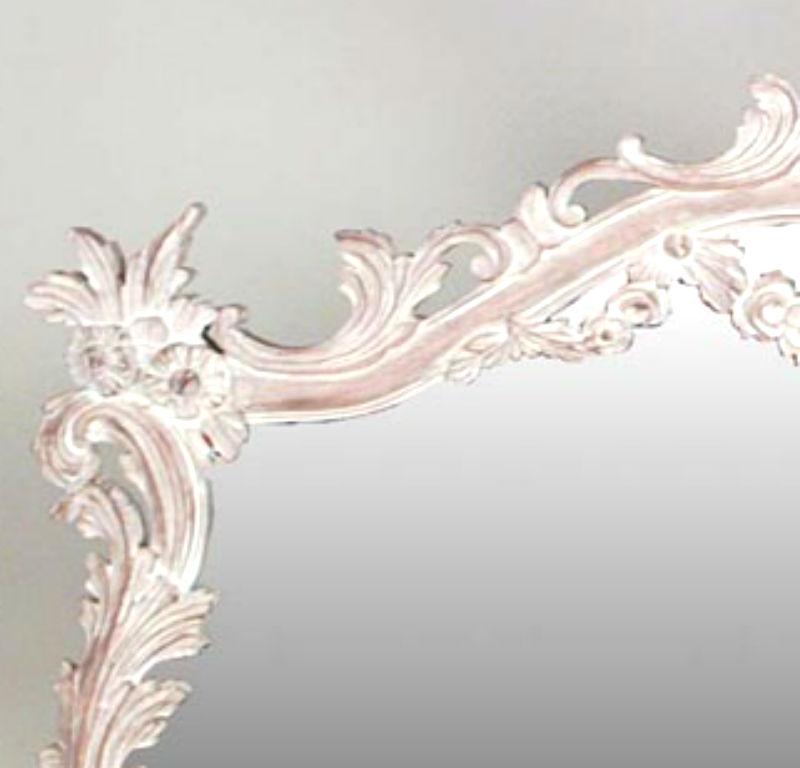 French Louis XV-style (20th Century) carved bleached horizontal wall mirror with two festoons and carved floral corners at top.
