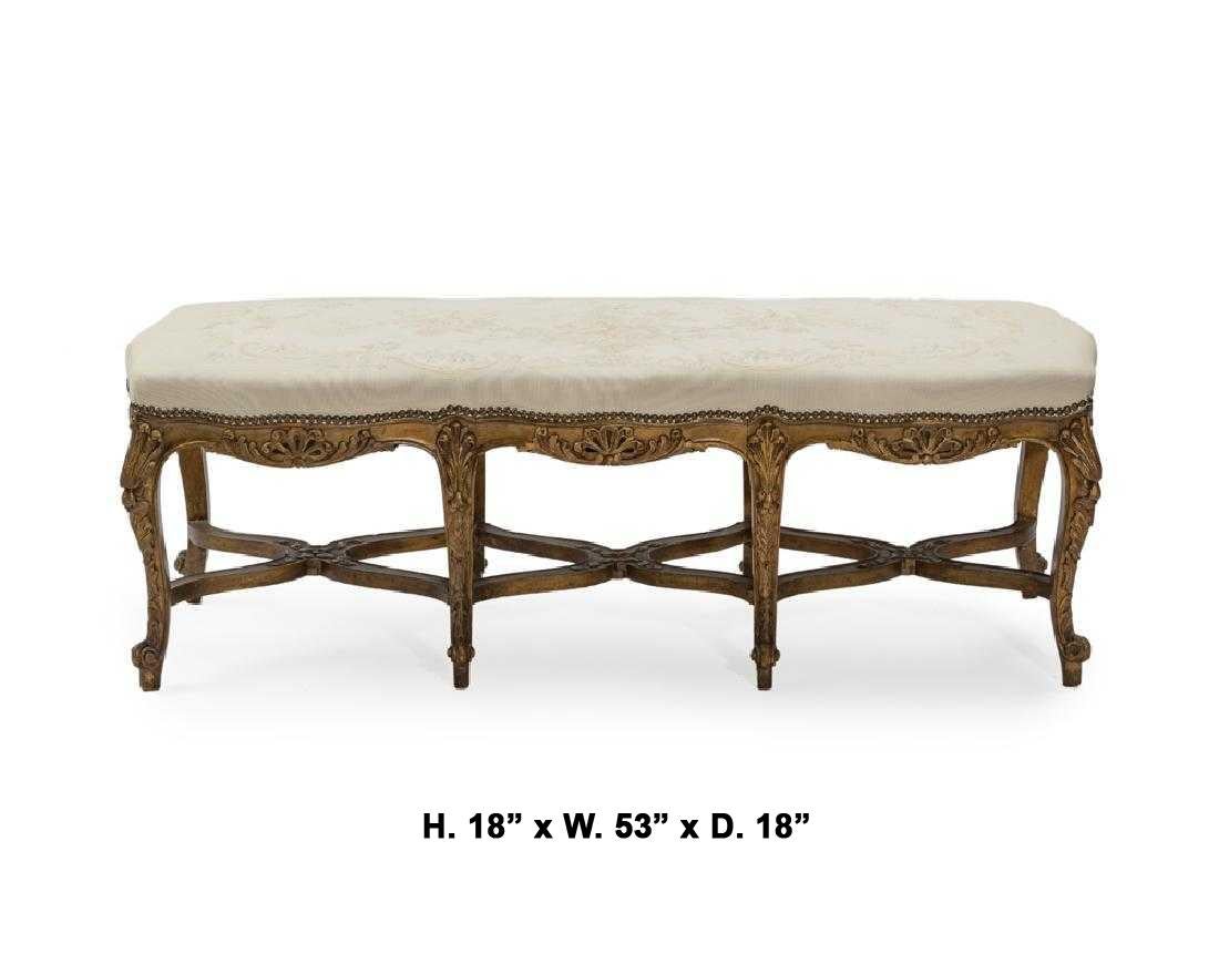 Attractive French Louis XV style carved giltwood bench, late 19th-early 20th.
The bench is finely carved with a foliage motif and supported with eight giltwood cabriole legs conjoined by X-form stretcher.
The seat is upholstered and pinned.