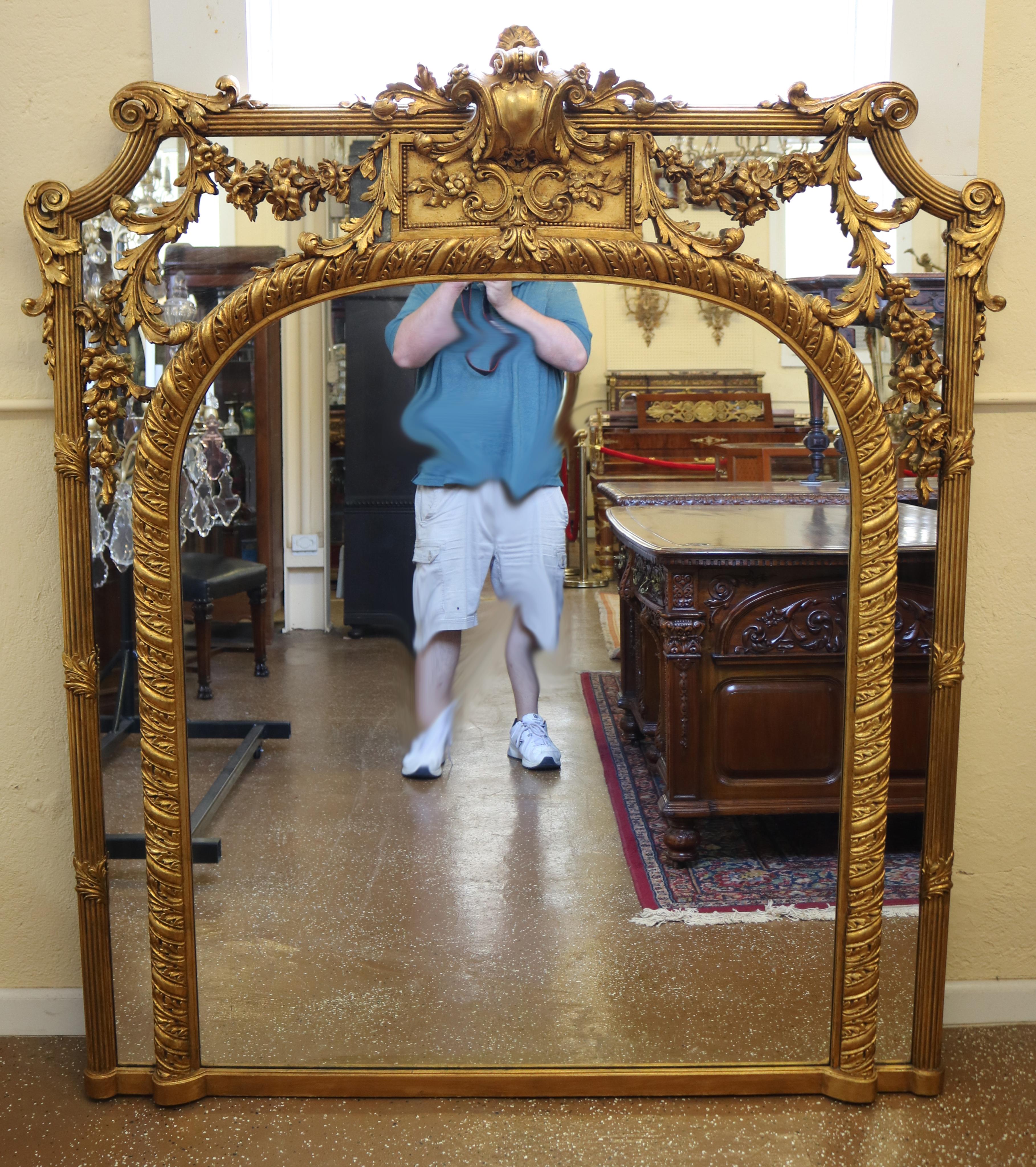 This gorgeous mirror was made in France in the turn or the 20th century. The mirror has stunning carvings and a beautiful form! The back has been replaced and is very strong with a strong wall hanger attached!