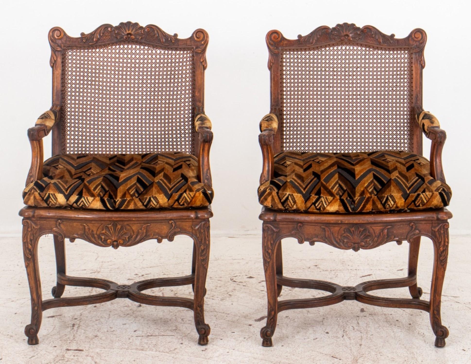 French Louis XV style pair of oak armchair or fauteuil a la reine raised on cabriole legs joined by stretchers with carved shell and acanthus foliage motif to backrest and apron, having caned seat and back, circa nineteenth century.

Dealer: S138XX
