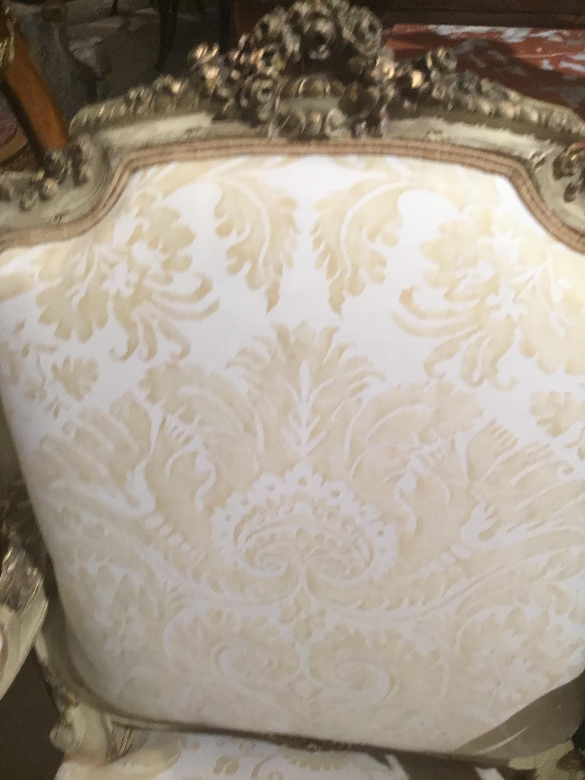 Parcel paint and parcel giltwood carved 19th century armchair/ fauteuils
Upholstered in new Fortuny fabric. The finish is in antique condition,
With lovely shades of cream paint and highlights F-gold gilt. A crest of
Flowers is centered at the