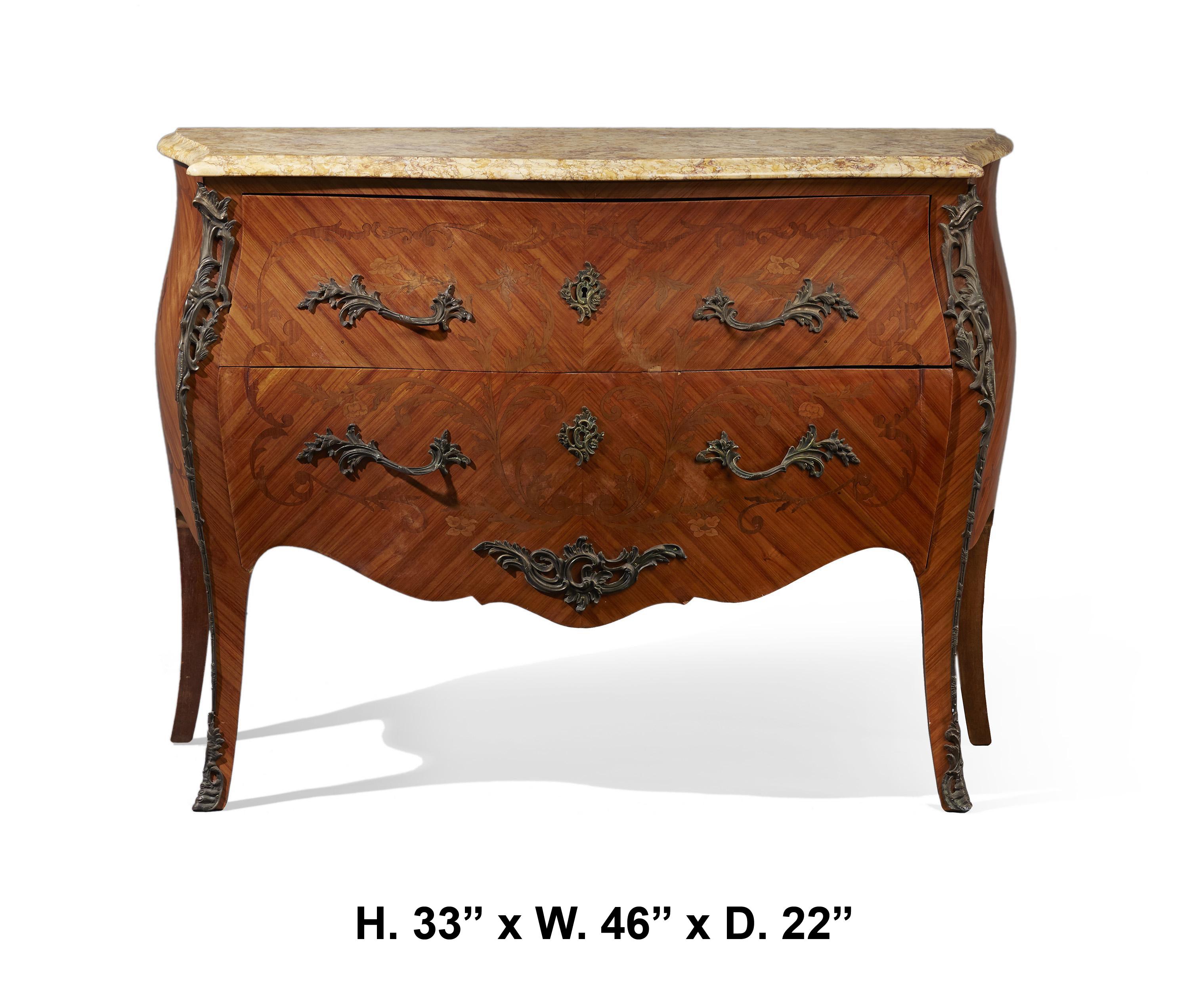 Beautiful French Louis XV Style commode with marble top, early 20th century.
The moulded serpentine-shaped mottled marble top, is over two marquetry veneered long drawers mounted with foliate inspired handles and escutcheons, the corners are bronze