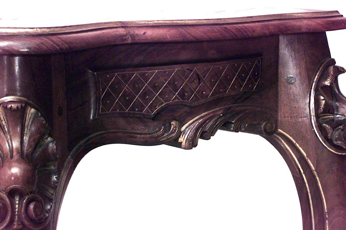 French Louis XV style walnut and gilt trimmed console table with shell stretcher, 19th century.
 