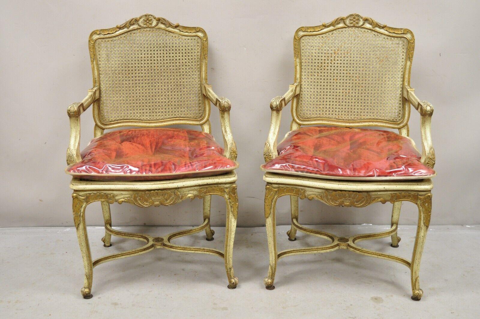 Vintage French Louis XV Style Cream Painted Carved Wood Cane Fauteuil Arm Chairs - a Pair. Circa Mid 20th Century. Measurements: 38