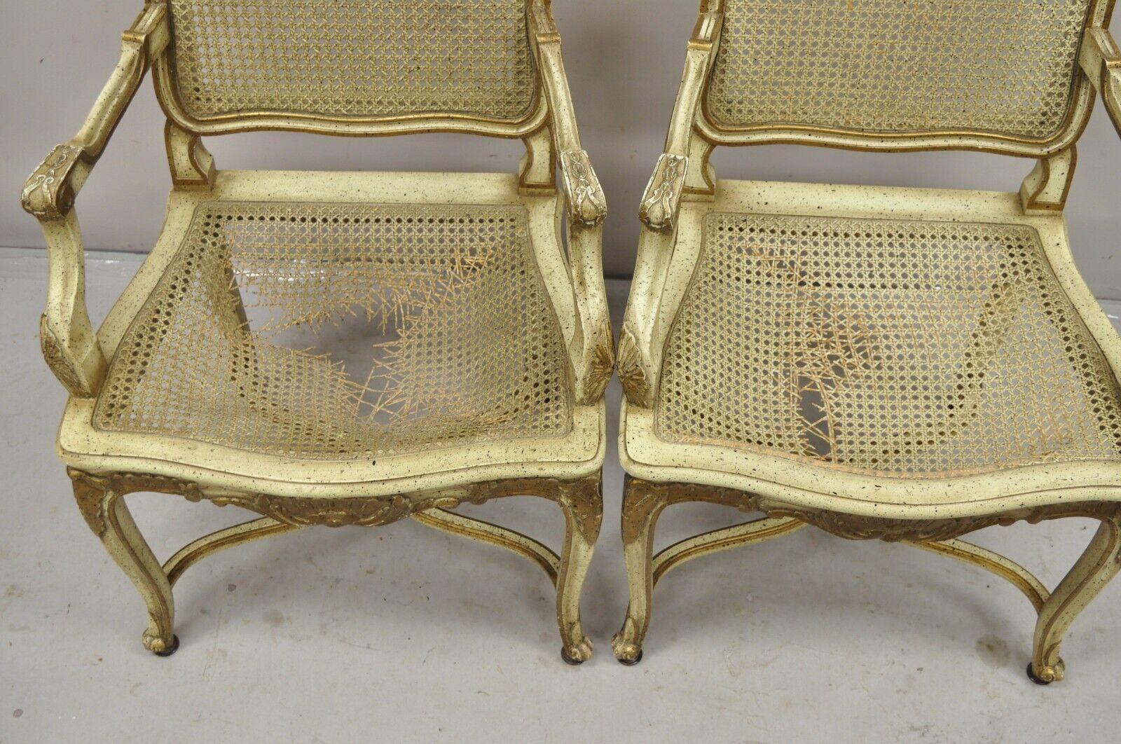 French Louis XV Style Cream Painted Carved Wood Cane Fauteuil Arm Chairs - Pair In Good Condition For Sale In Philadelphia, PA