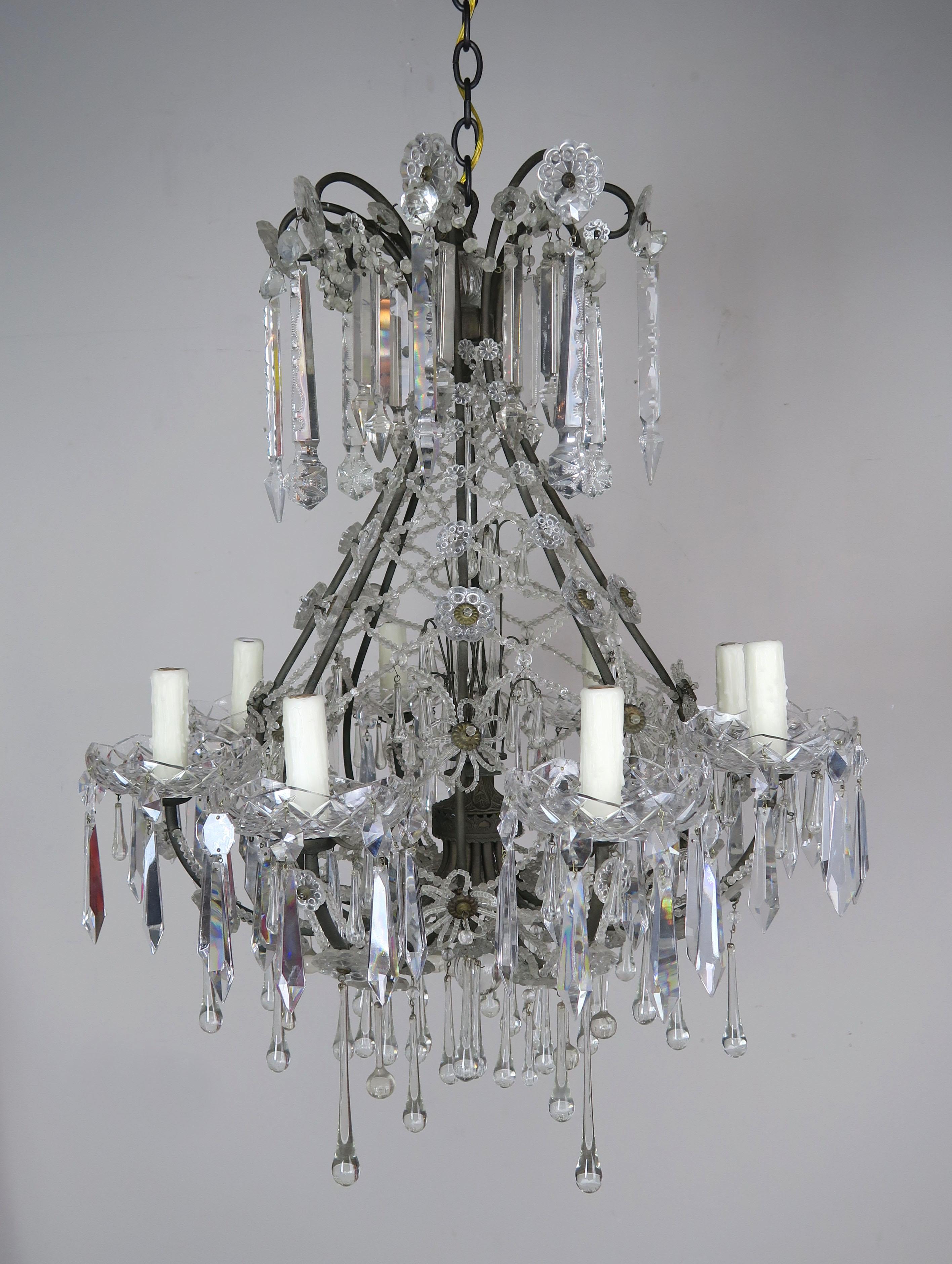 French Louis XV style 8-light beaded crystal chandelier. The fixture is adorned with unique hand cut crystal spheres and drops throughout. An intricate lattice work design is made with tiny beads and separated with handmade beaded flower accents.