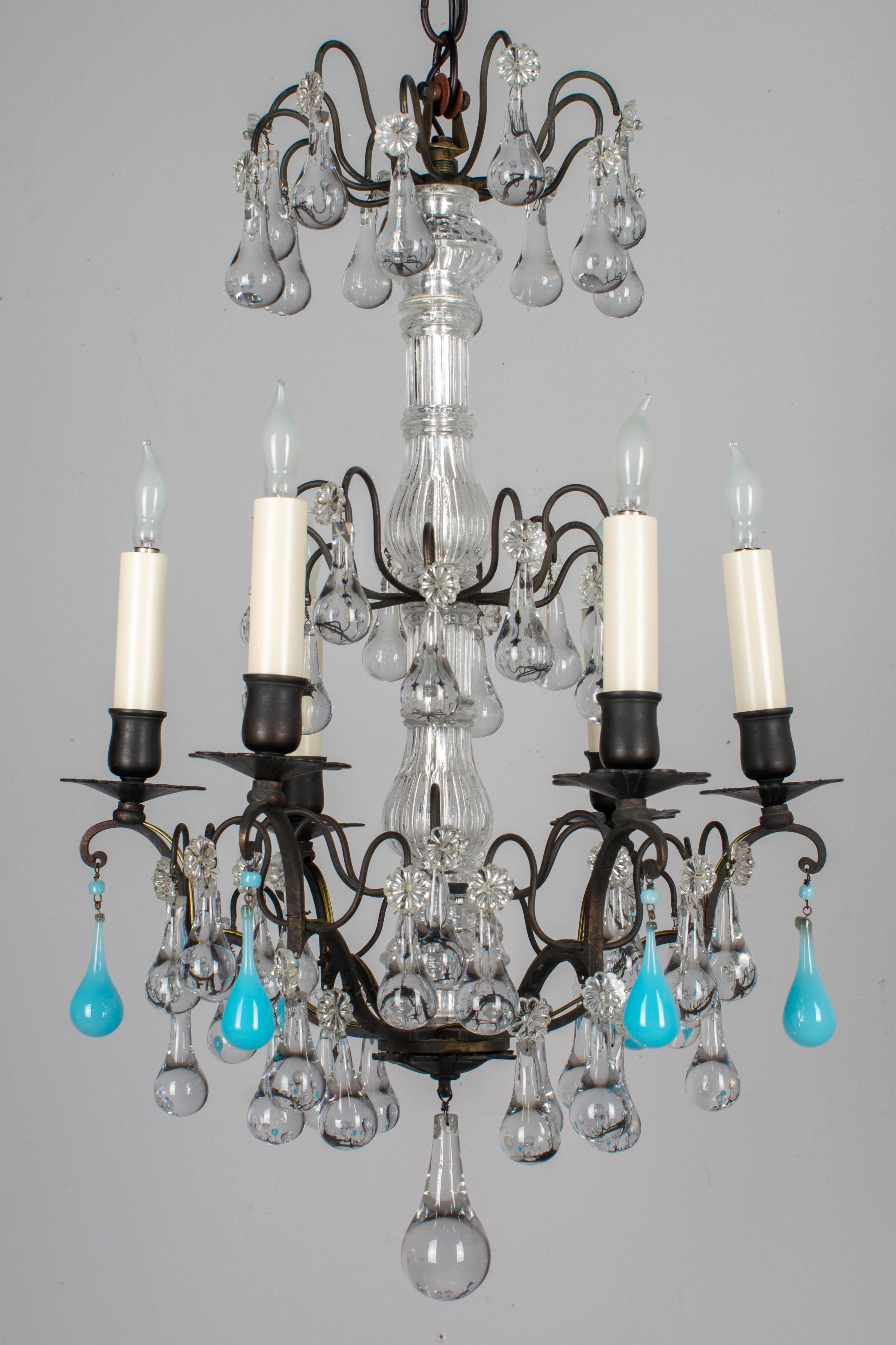 A French Louis XV style six-light chandelier with clear glass teardrops, rosettes and columns and accented with six turquoise blue glass teardrops. All original, as found. Brass frame with dark bronze patina. Rewired with new sockets and candle