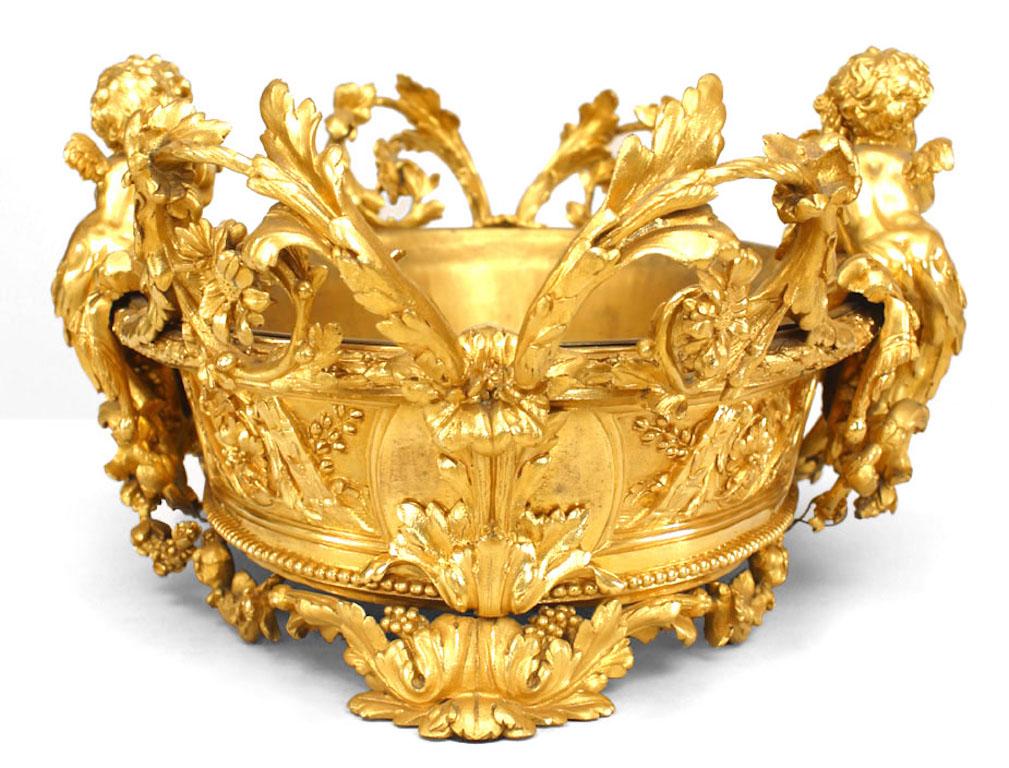 French Louis XV-style (19th Century) oval bronze dore cupid design centerpiece with double scroll handles.
