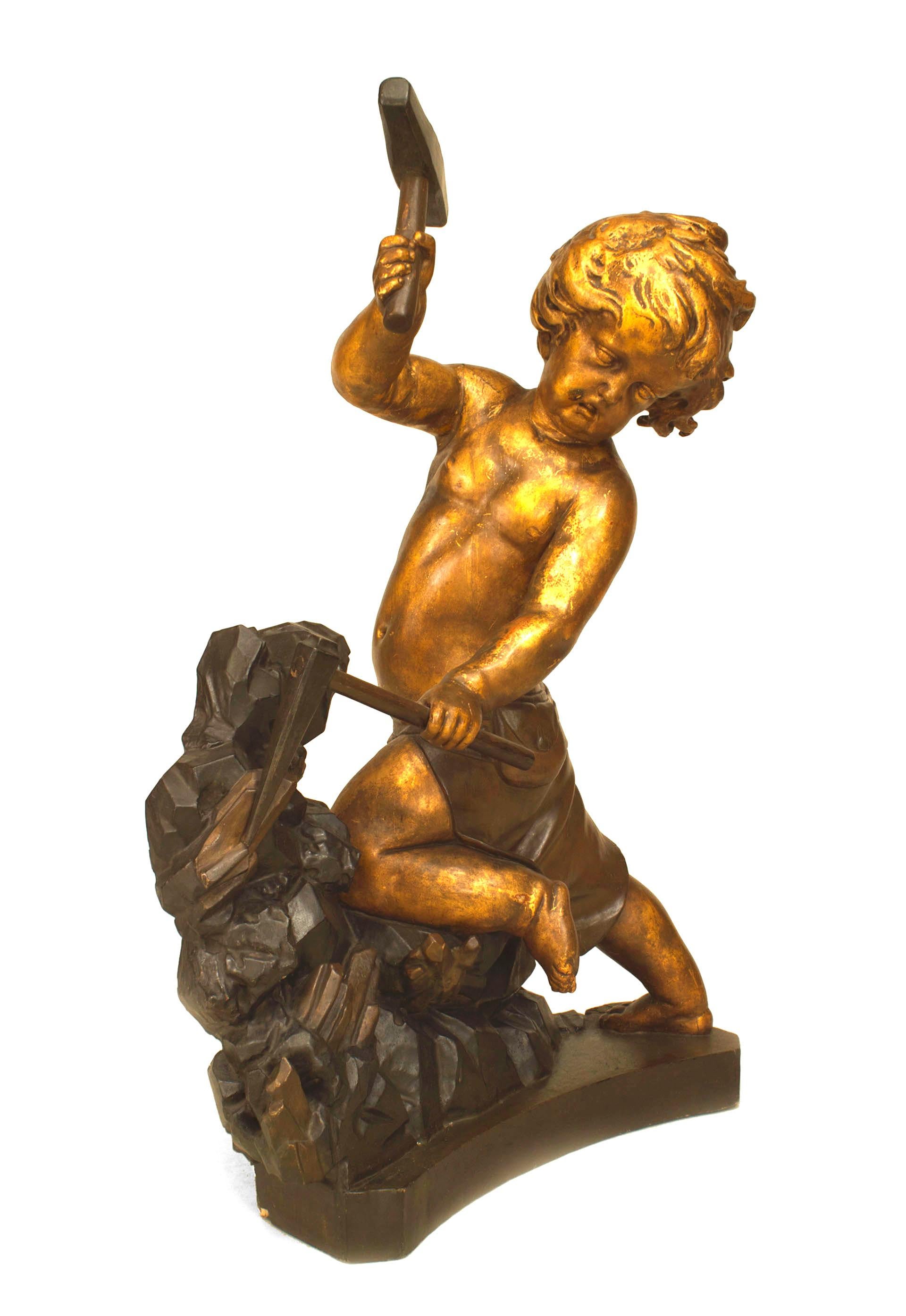 French Louis XV style (19th Cent) painted and gold trimmed figure of cupid with hammer and chisel.
