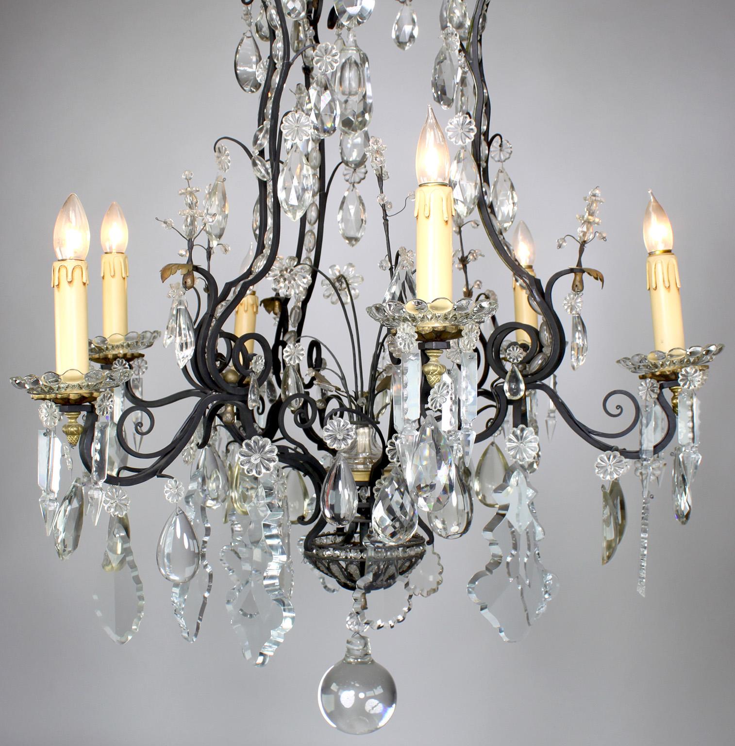 A Fine French Louis XV Style Cut-glass, Wrought Iron and Parcel-Gilt Six Light Chandelier. The scrolled ebonized iron frame surmounted with cut-glass pendants and prisms, the flower glass petals set within a gilt background, with molded glass