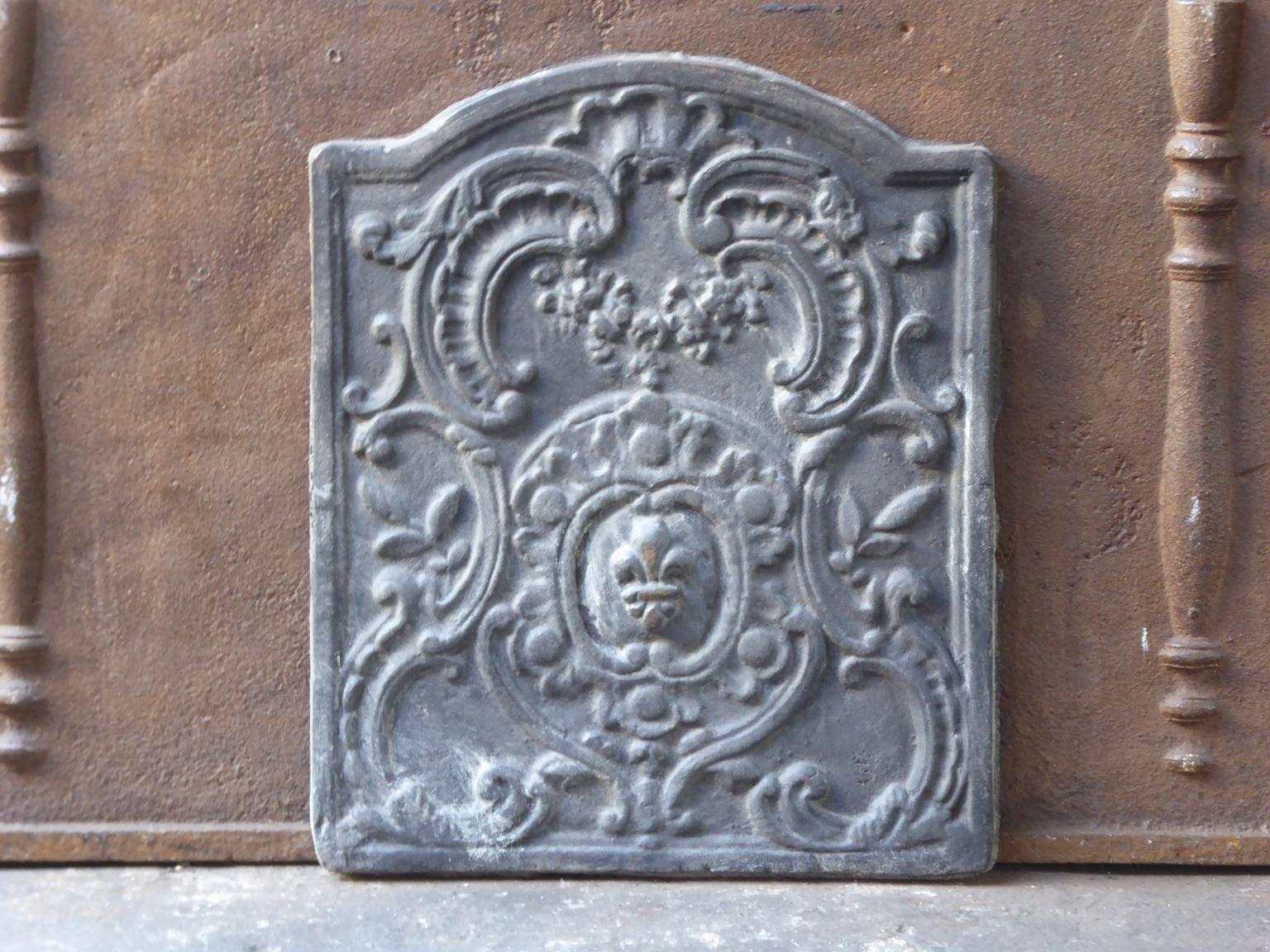 20th century French fireback with Louis XV style decoration. The fireback is made of cast iron. It is in a good condition and does not have cracks.







 