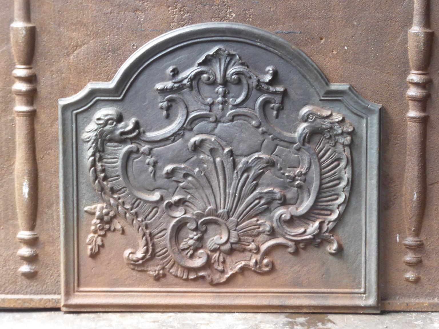 20th century French fireback with Louis XV style decoration. The fireback is made of cast iron. It is in a good condition and does not have cracks. The fireback has a natural brown patina. Upon request it can be made black / pewter.







 