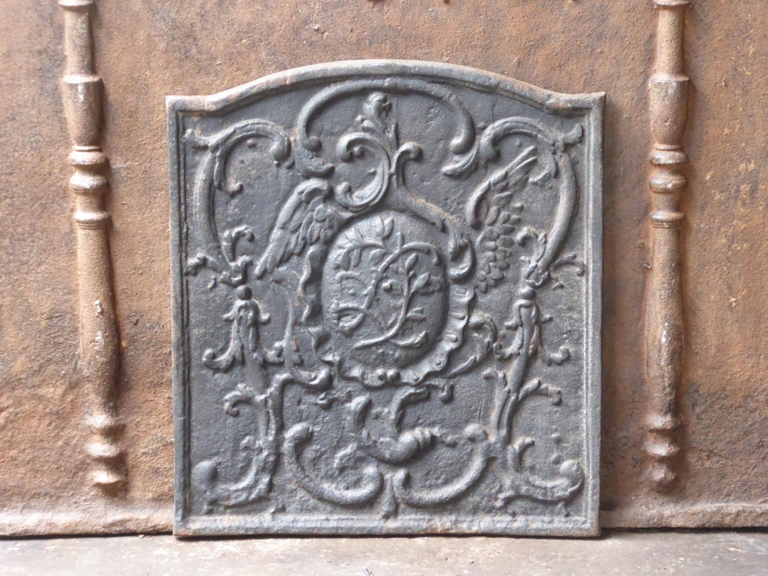 20th century French fireback with Louis XV style decoration. The fireback is made of cast iron. It has a black / pewter patina. 







 