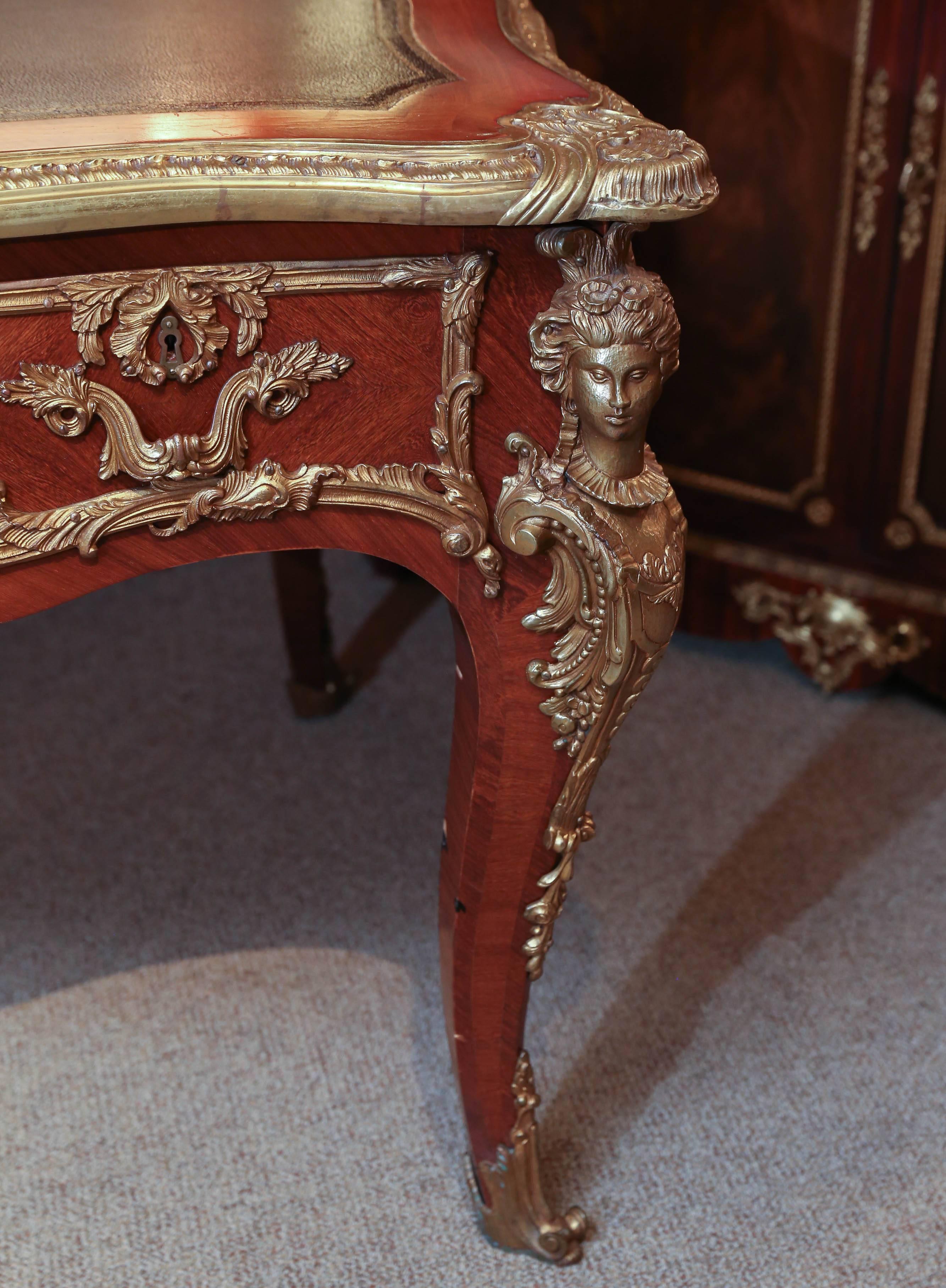 Large impressive desk with inset leather top surrounded
By gilt trim and brass edge over three drawers, the back
Accented with faux drawers, rising on cabriole legs with
Pilaster mounts to knees.