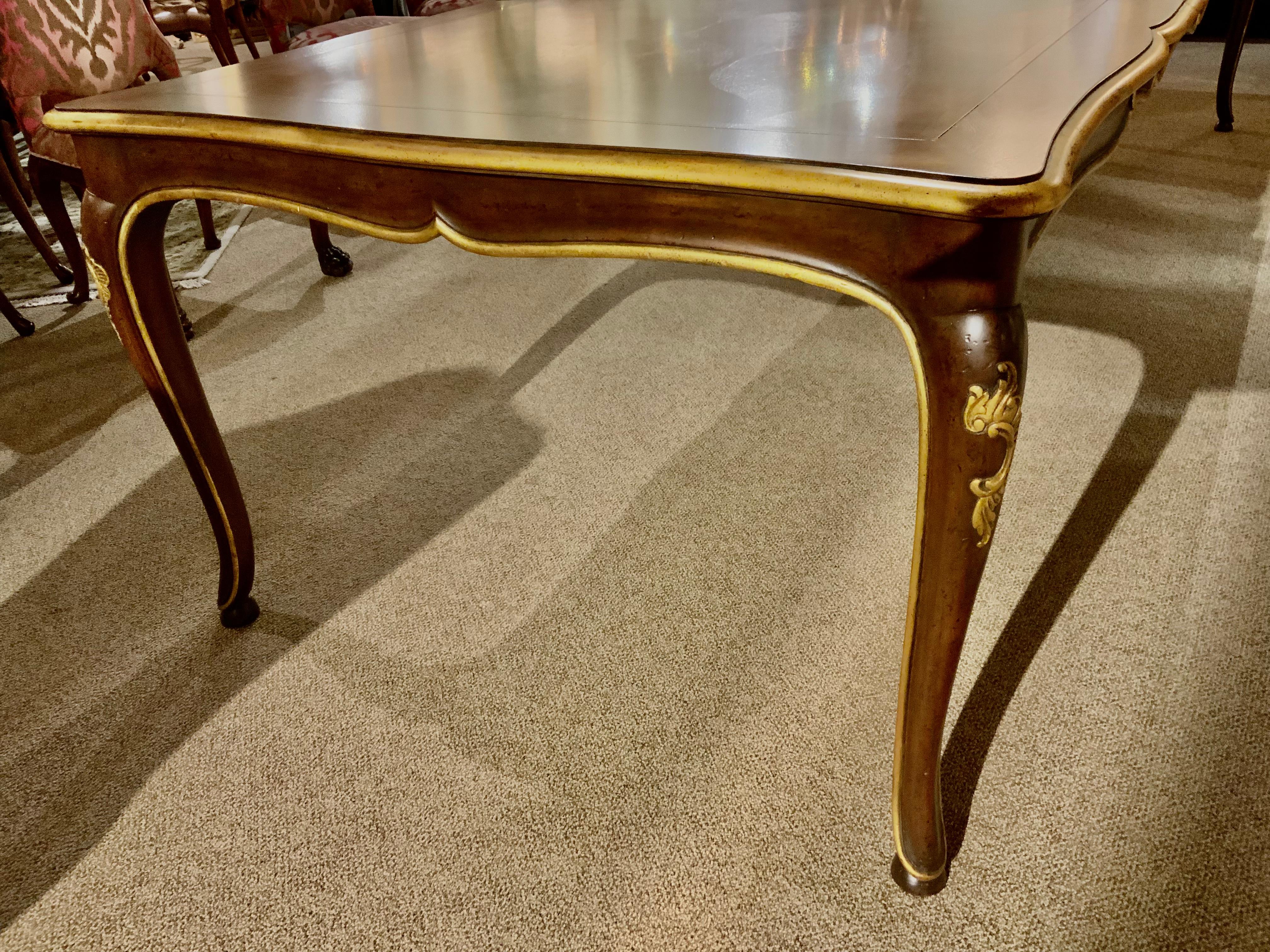 Dining table in the Louis XV-Style with gently curved legs and a curve
To the top of the table. A marquetry design in a lantern shape embellishes
The top surface. A gilt finish in a warm gold surrounds the top edge of
This table and the apron and