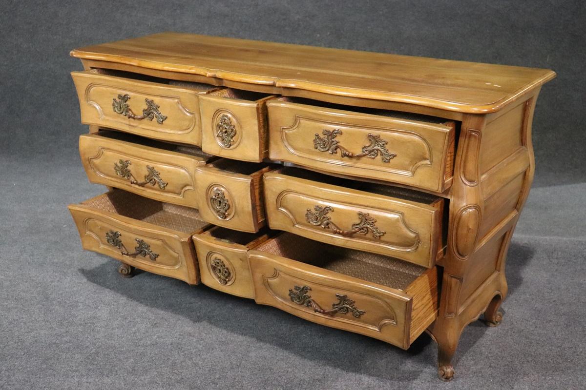 This is a spectacular French Louis XV style 9-drawer dresser that has all of the quality you would expect in the finest Auffray pieces. The drawers are solid oak secondaries and they are beautifully lined with fine Italian paper. There are numerous