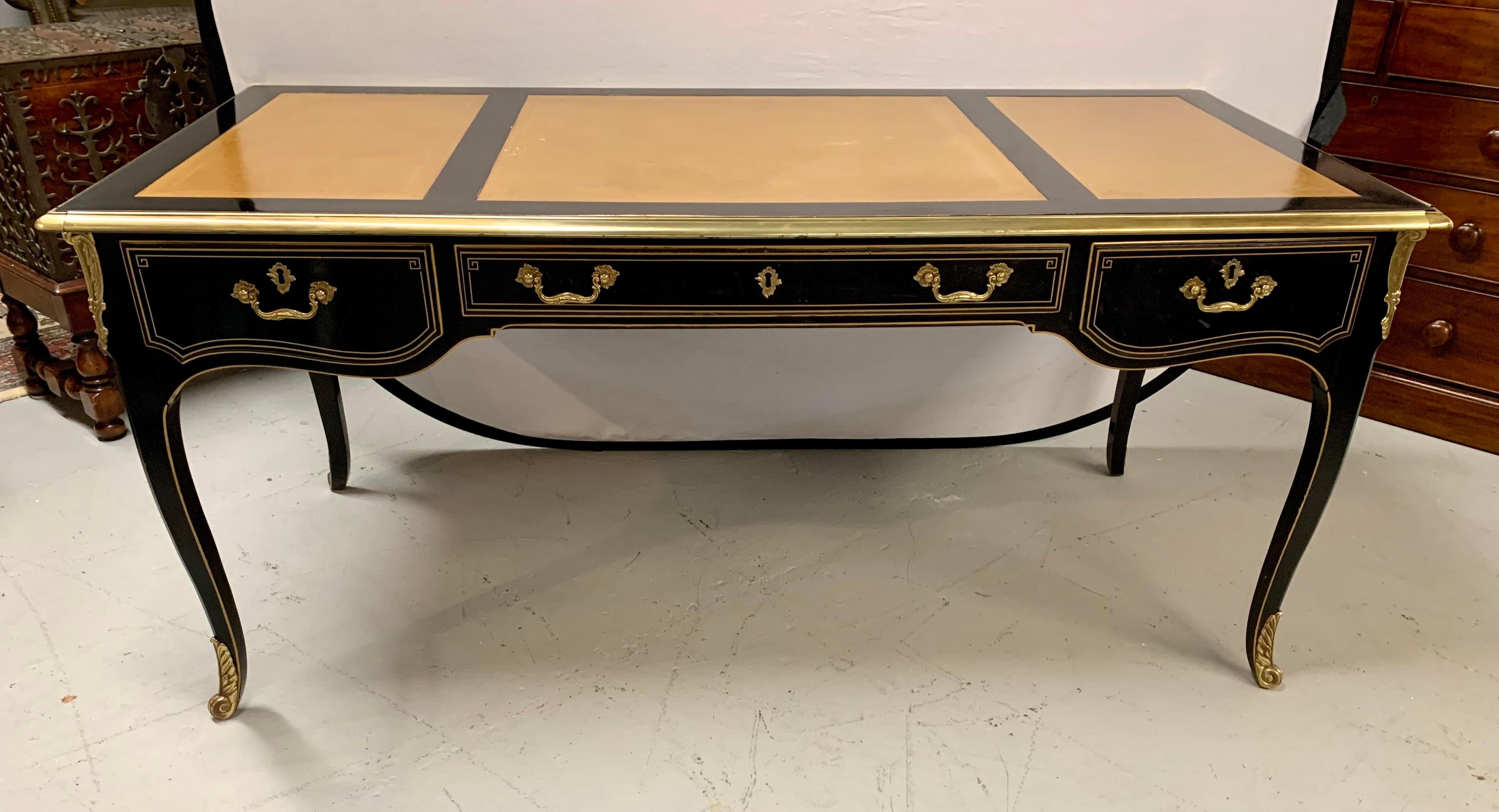 A beautiful French Louis XV style ebonized wood desk bearing ormolu mountings throughout the three drawer desk, with an inset leather writing surface.