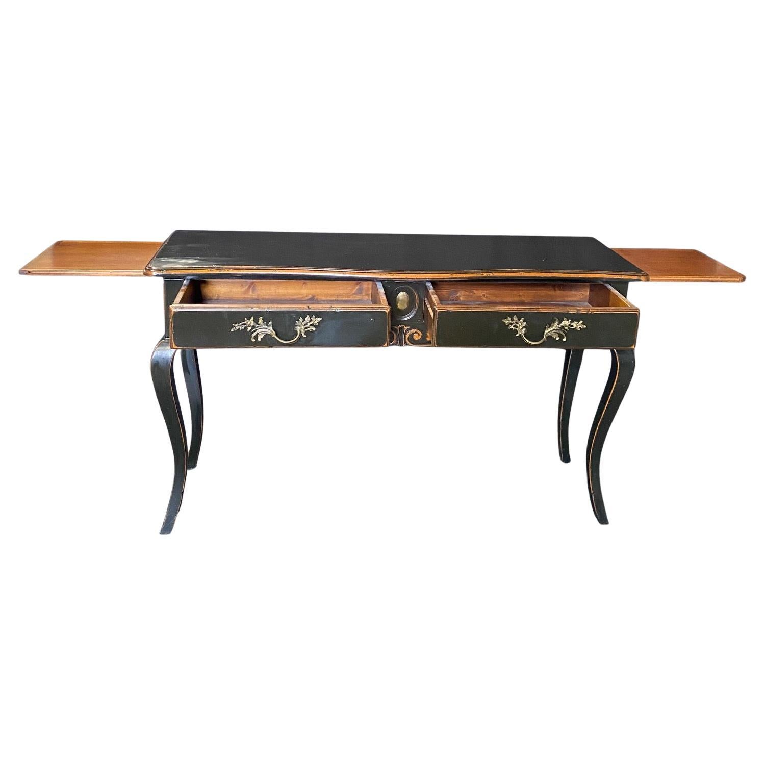 Exquisite black ebonized console table crafted in the French Louis XV style, with contrasting gold hardware that beautifully complements the black finish, creating a striking visual contrast. With its sleek and slender design, this console table is