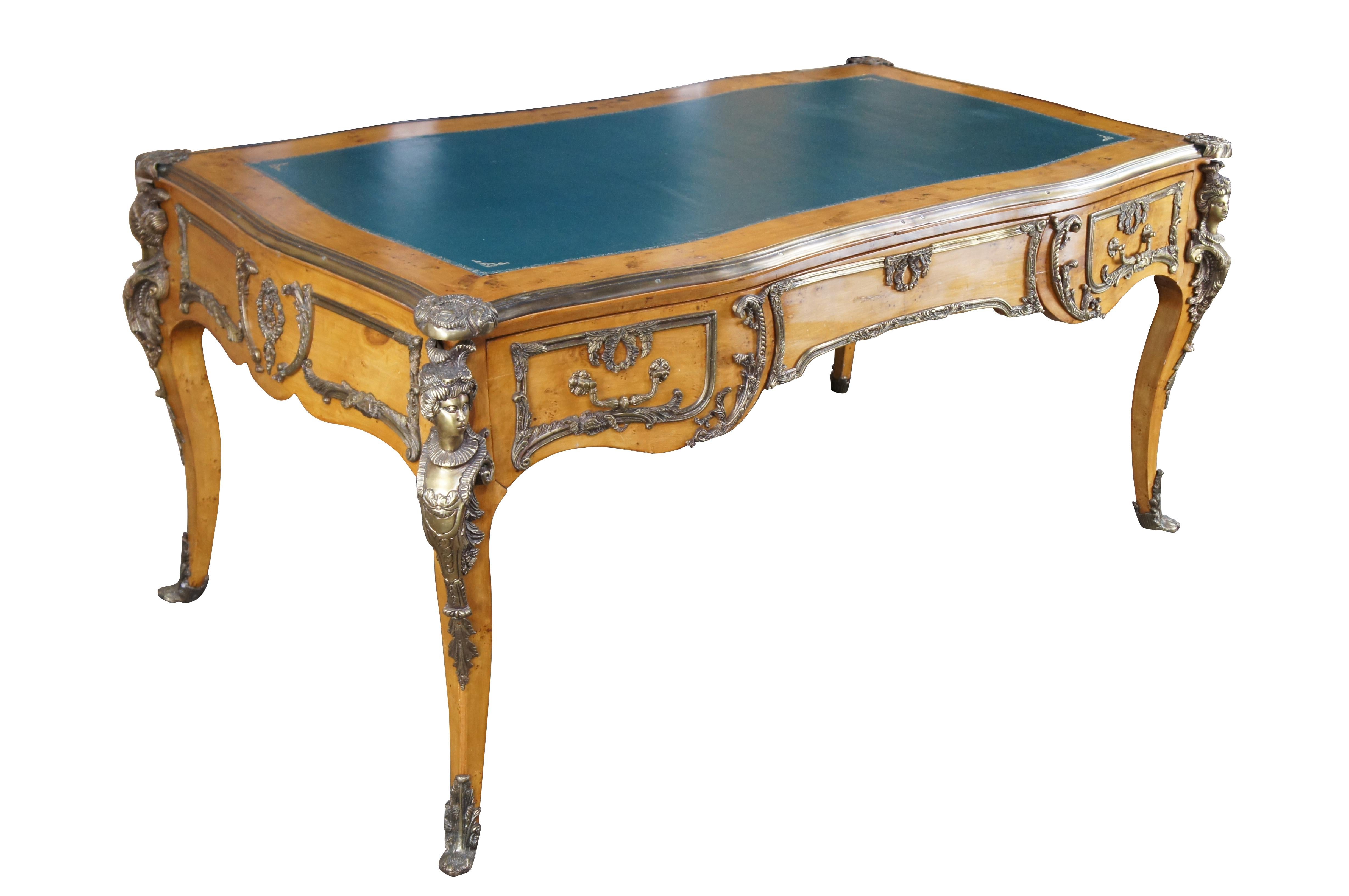 Monumental Louis XV / Napoleon III style office desk. A serpentine form made from birdseye maple with three large dovetailed drawers in the frieze and long tapered cabriole legs. Features an inset tooled green leather top and ornate neoclassical