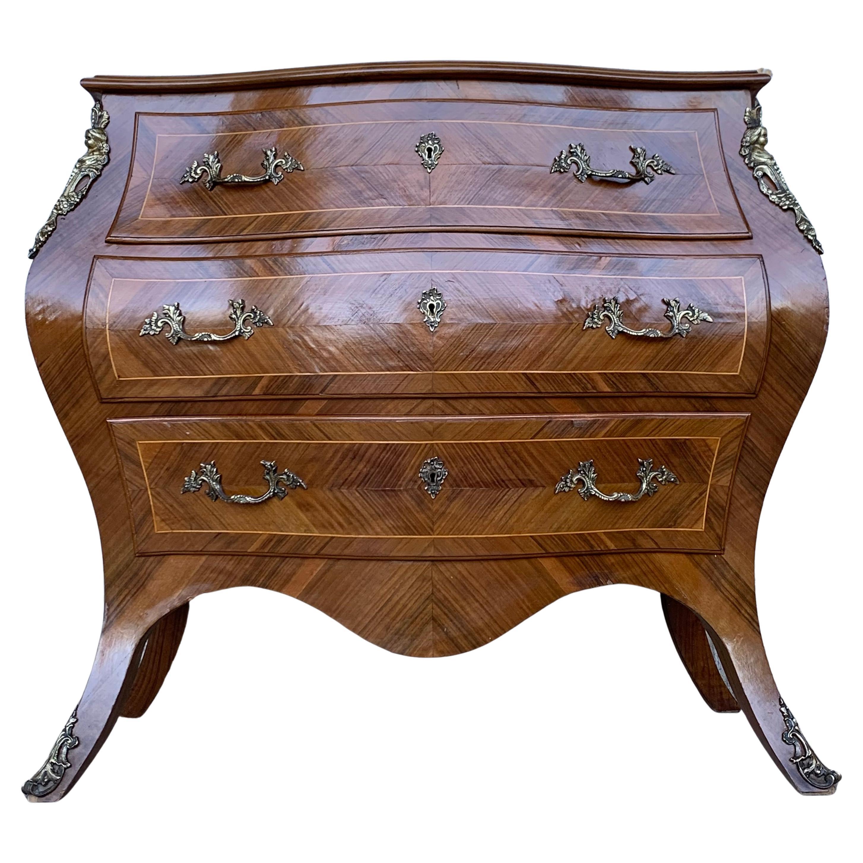 French Louis XV style kingwood veneer commode, the shaped marble top above a bombe case with ormolu bronze mounts, highly decorated throughout with marquetry inlay with three drawers, on short cabriole legs.


