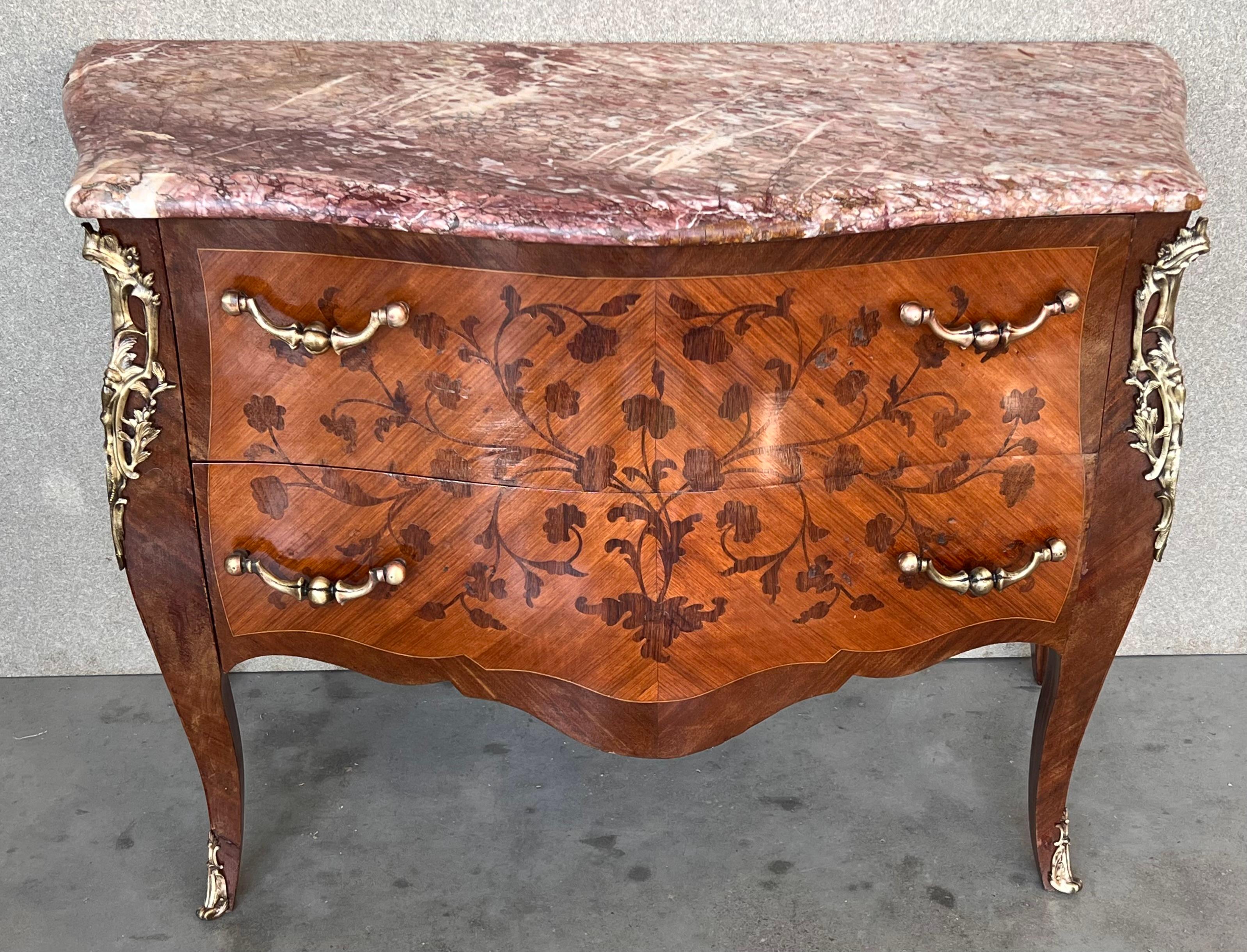 French Louis XV style kingwood veneer commode, the shaped marble top above a bombe case with ormolu bronze mounts, highly decorated throughout with marquetry inlay with two drawers, on short cabriole legs.


