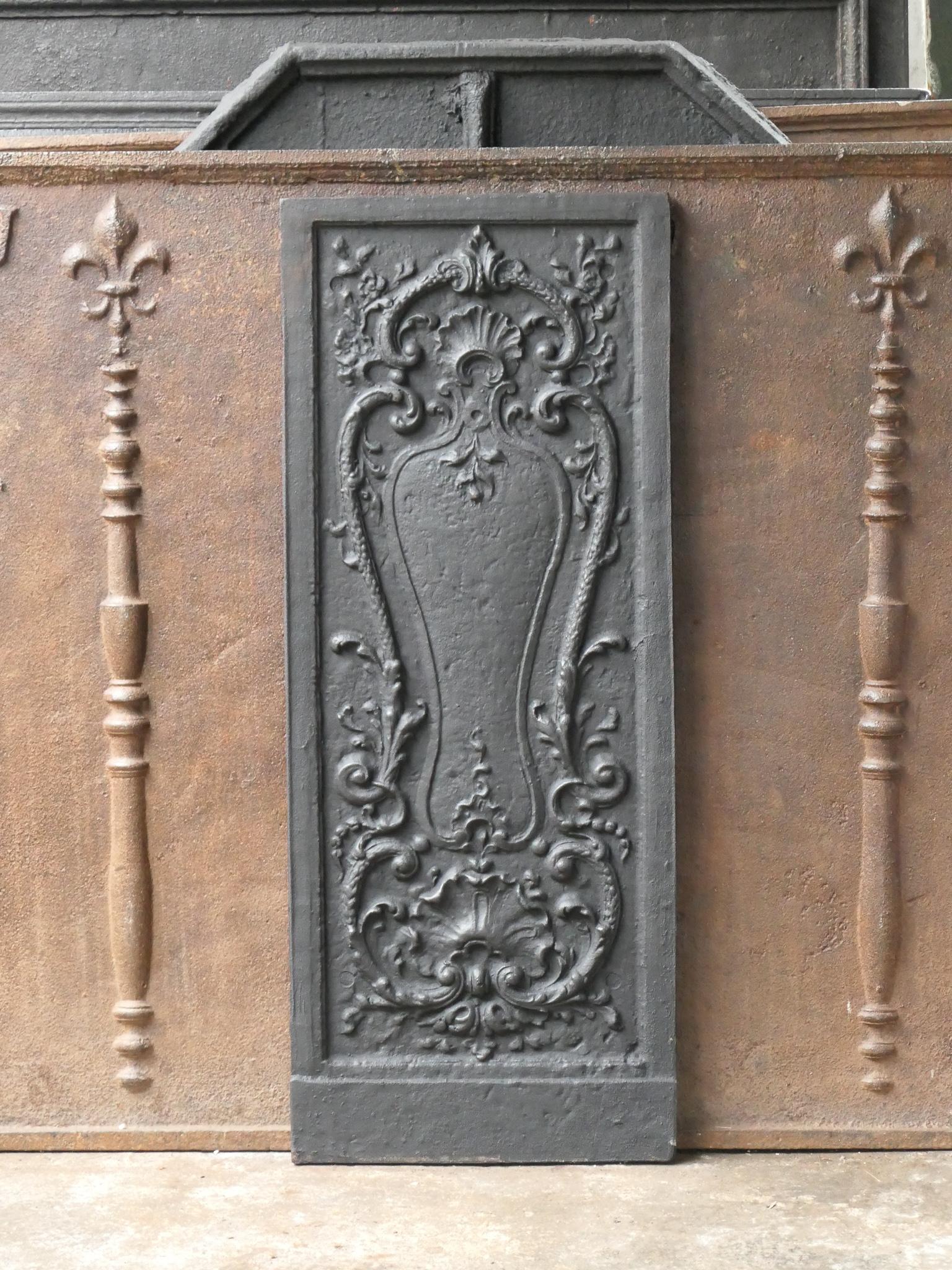 20th century French Louis XV style fireback. The fireback is made of cast iron and has a black / pewter patina. The condition is good, no cracks.