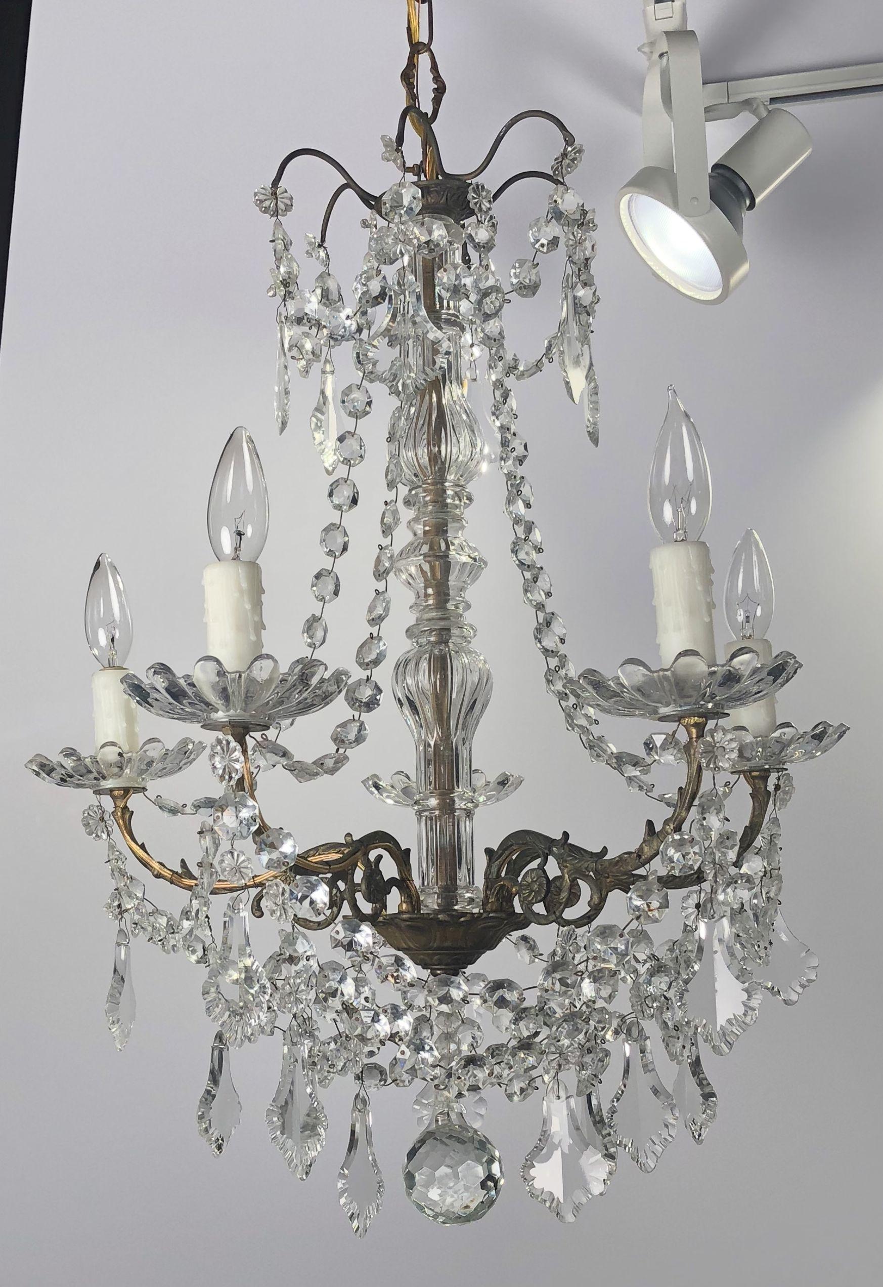 A lovely French five-light chandelier (or hanging fixture) of crystal, glass and gilt metal, in the Louis XV style, featuring serpentine arms, each candle light with dangling pendants and decorative bobeches.

Dimensions: Diameter 21 inches x