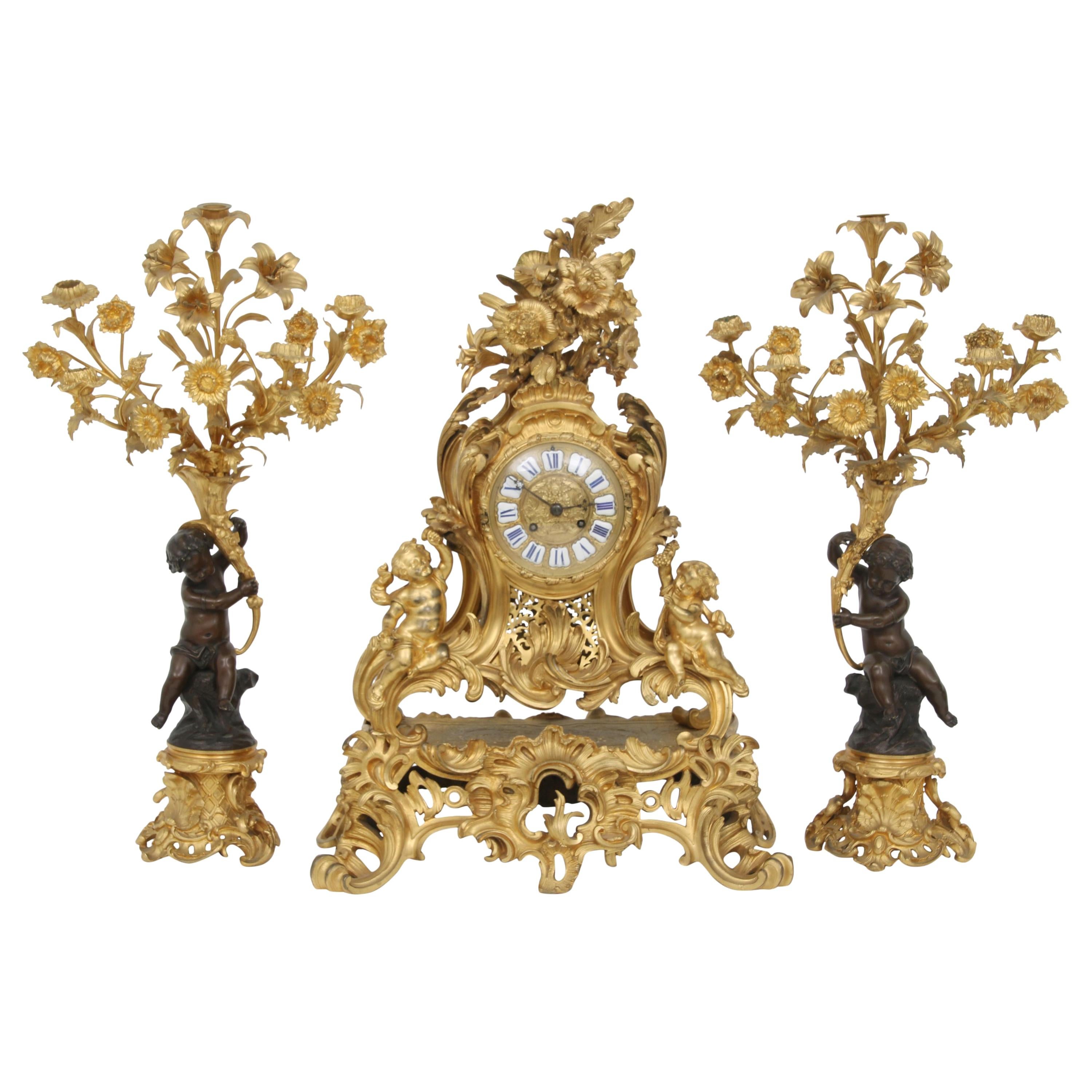 French Louis XV Style Gilt and patinated Bronze Clock and Candelabra