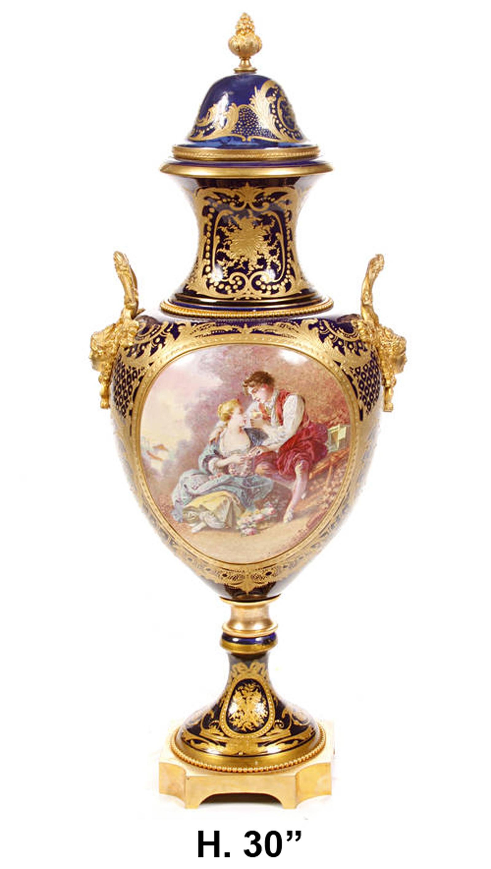 French Louis XV Sevres style gilt bronze mounted covered urn. 
Early 20th century.

Surmounted by a gilt bronze fruiting finial, over a removable domed lid and a gold etched neck, above a ovoid shaped porcelain body with a central hand painted