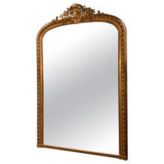 French Louis XV Style gilt mirror with foliate crest, 20 th c.
