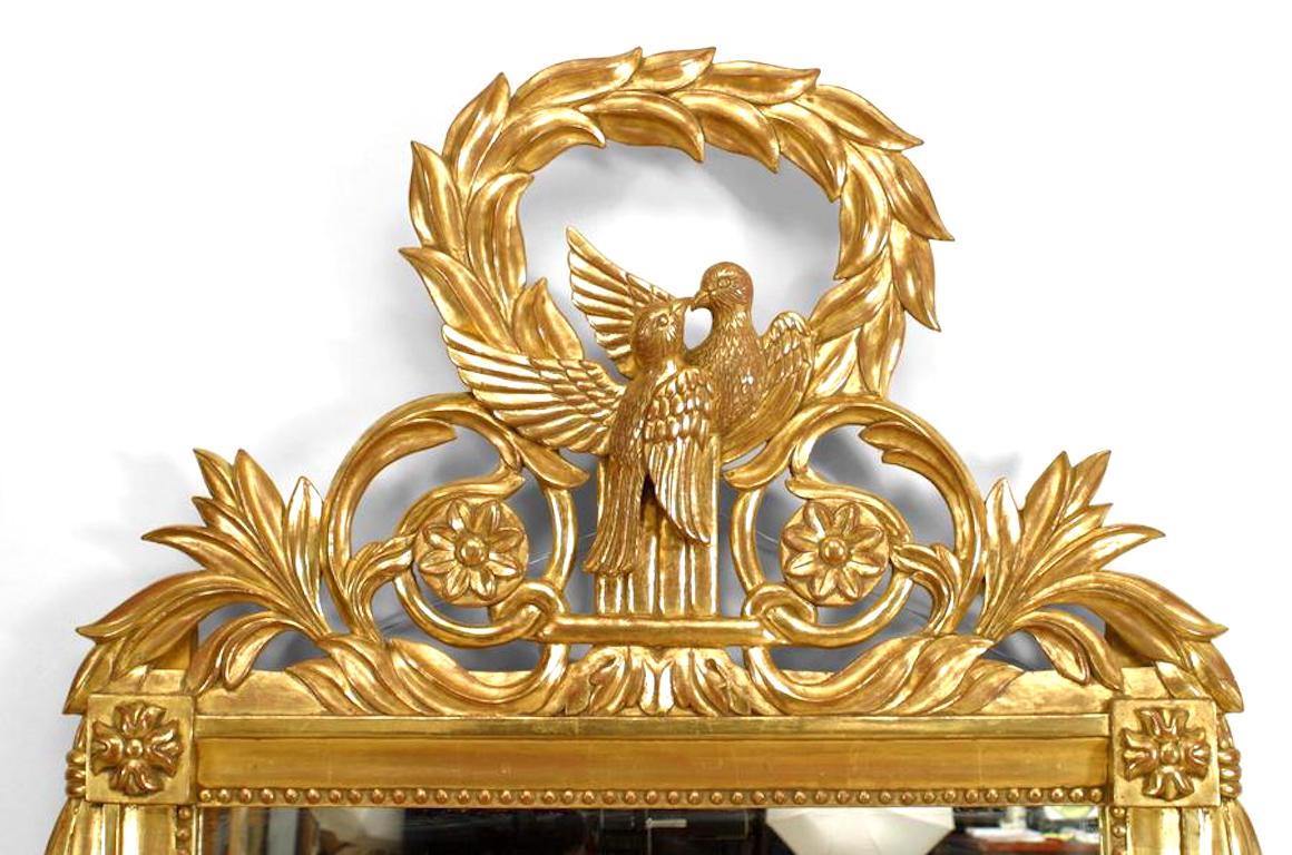French Louis XV style (modern) gilt wall mirror with two carved kissing birds and wreath pediment top.\
 
