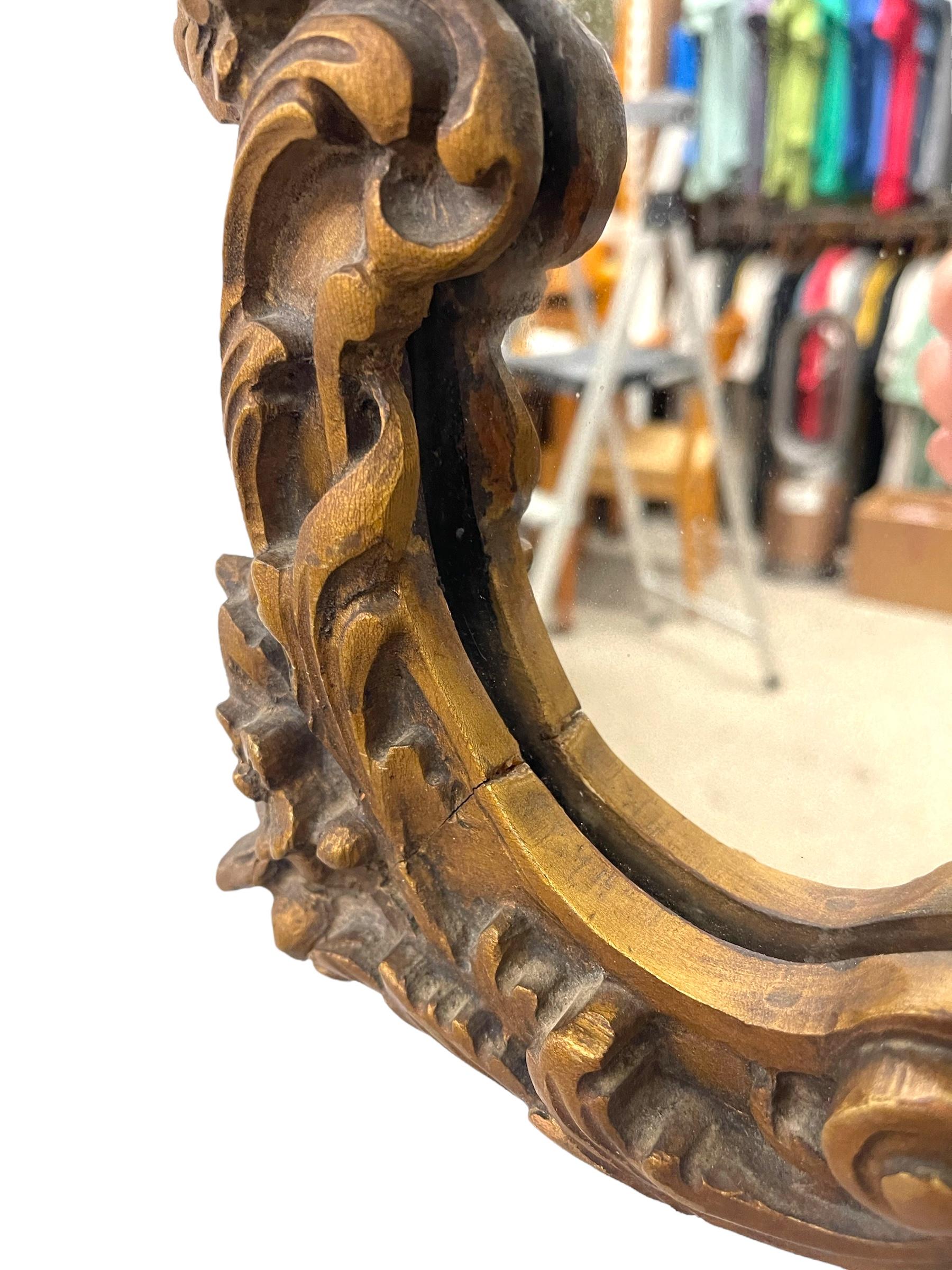 Miroir mural en bois doré de style Louis XV avec écusson en coquillage et détails floraux. Bon état - En vente à Seattle, WA