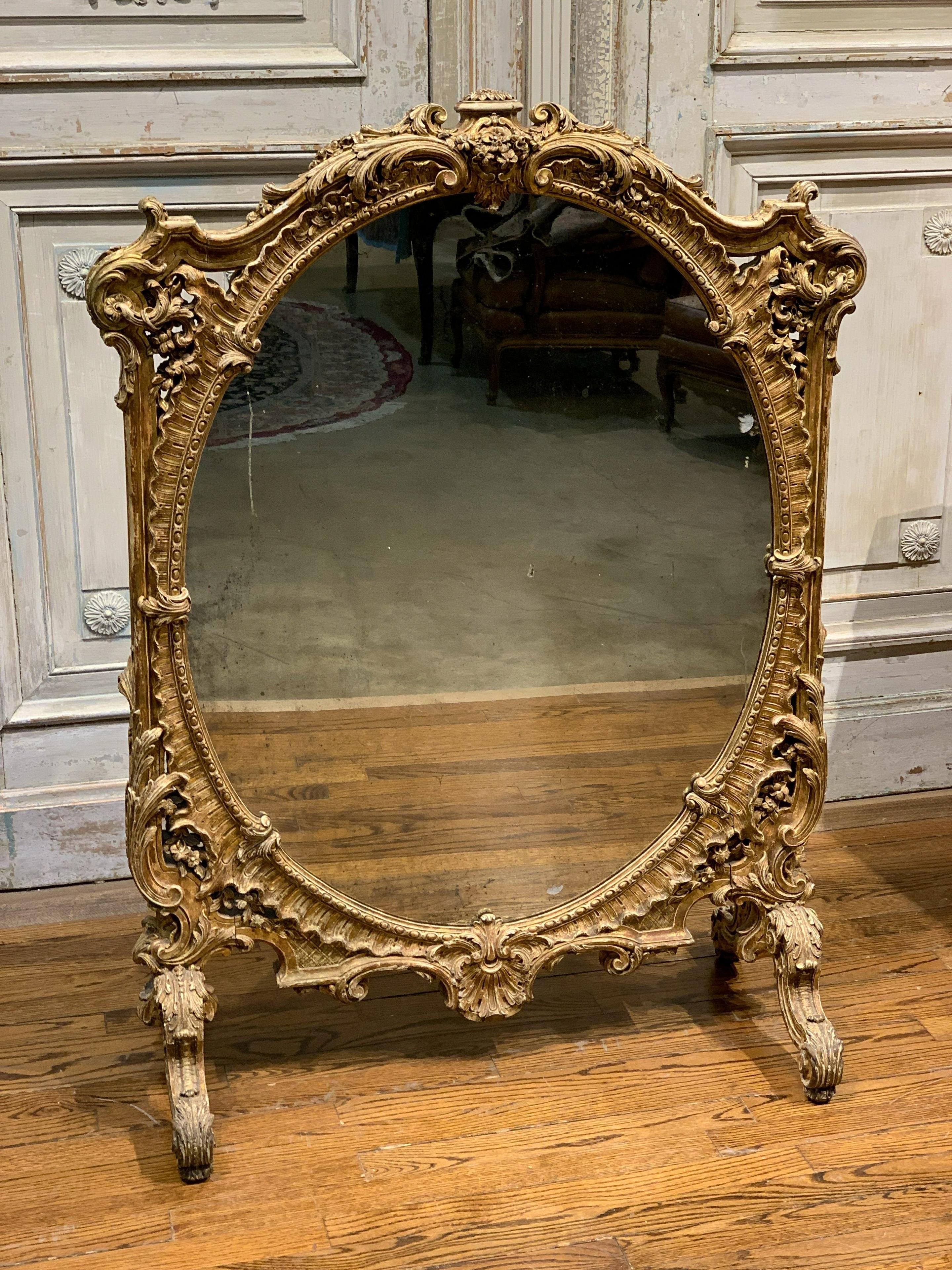 Very large French Louis XV style giltwood mirrored fire screen with the finest quality carving after a 18th century model.