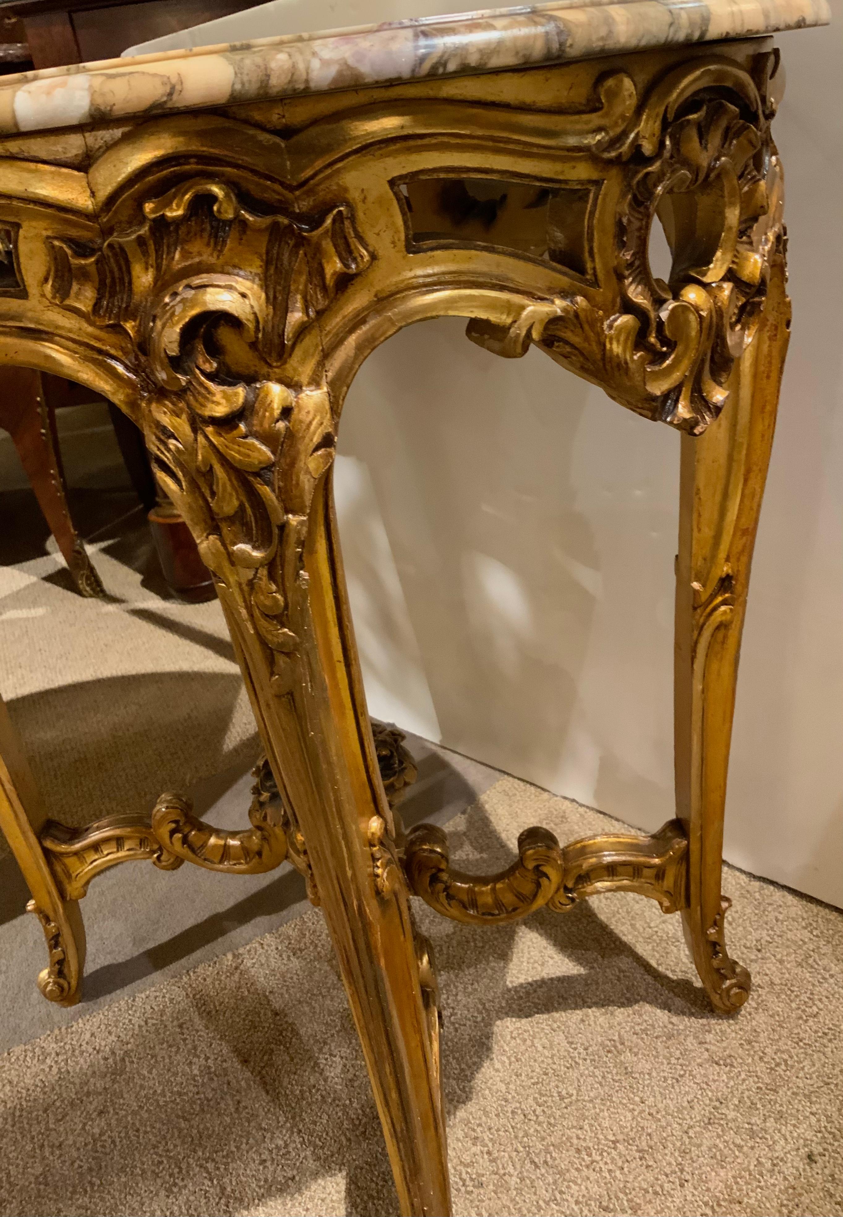 Graceful oval shape is a special attribute for this piece.
The carving is well done and it has curved shaped cabriole 
Legs in the Louis XV style. the marble is Breche de Violet
With a mix of cream, gold and violet hues. The apron of
This table