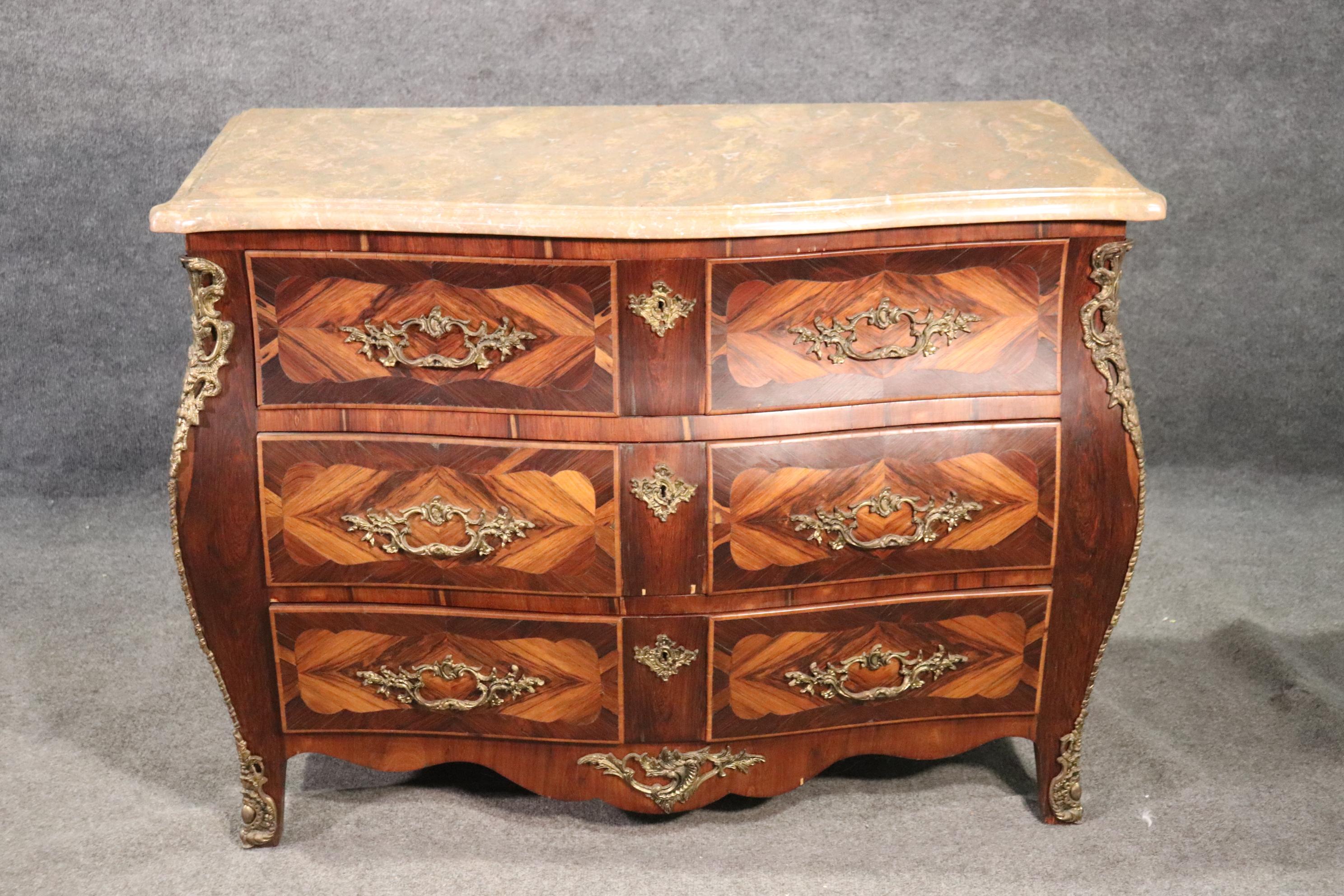 This is a beautifully designed French bombe commode or dresser. The marble top and teh case are in good condition. The piece measures 34 tall x 36 wide x 19 inches deep.