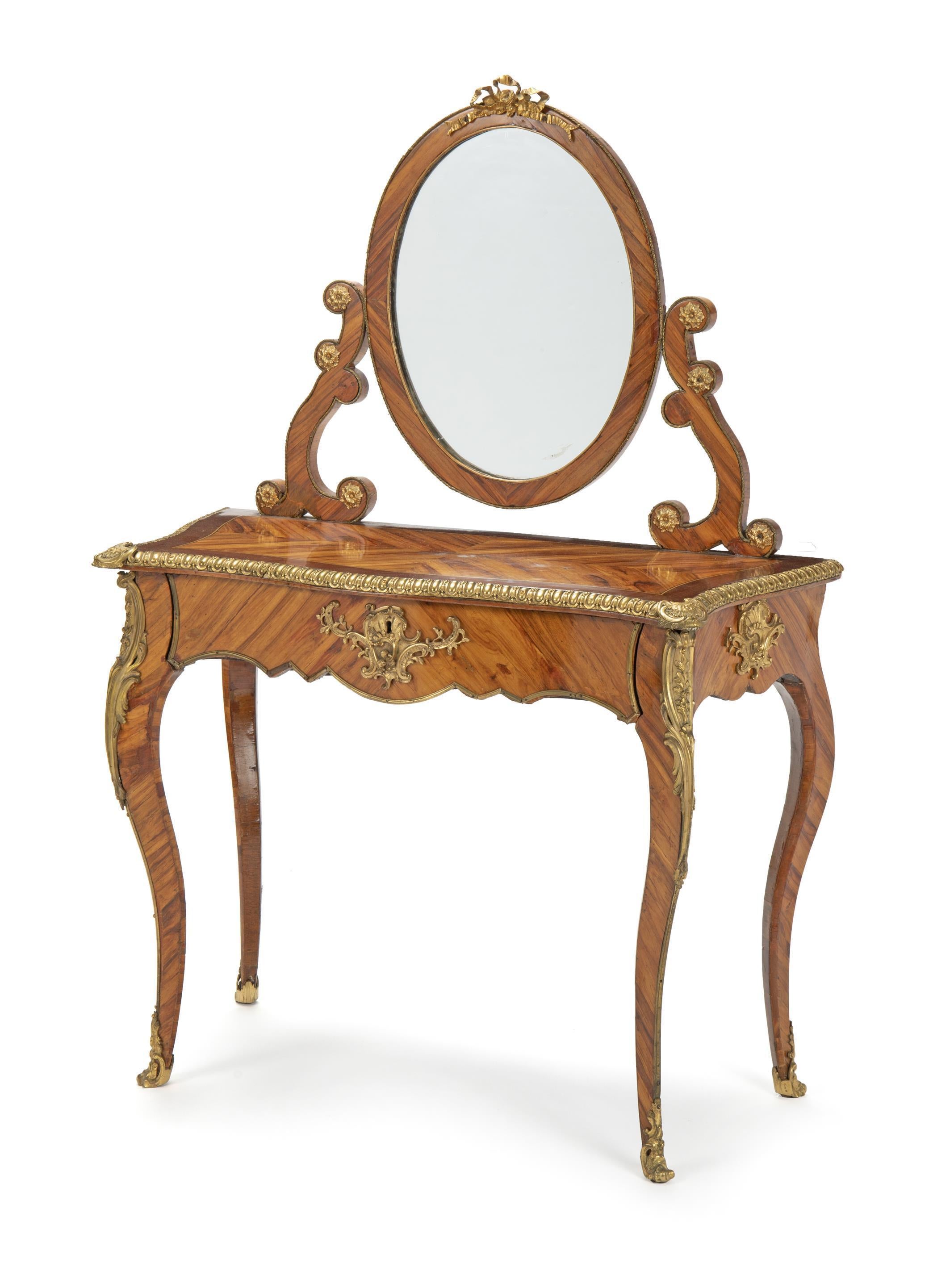 Attractive French Louis XV style kingwood vanities console with mirror.
19th century. 
The console is surmounted with an oval bronze mounted vanity mirror, supported by two carved scrolls with rosettes, above a moulded parquetry kingwood veneered