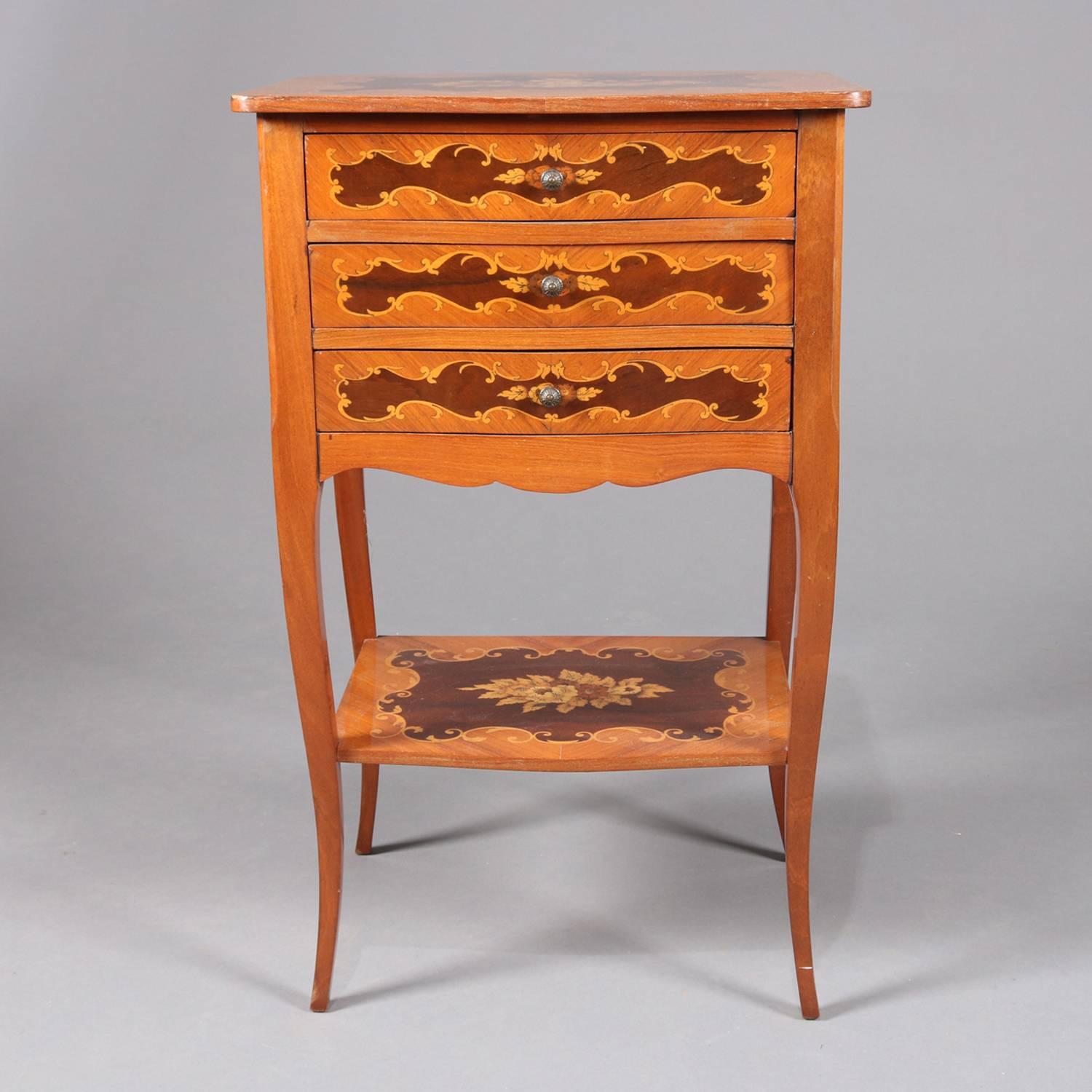 Floral Louis XV style kingwood stand features reserves of floral and scroll inlay marquetry with three drawers, lower shelf and raised on tapered cabriole legs, 20th century.

Measures: 27.5