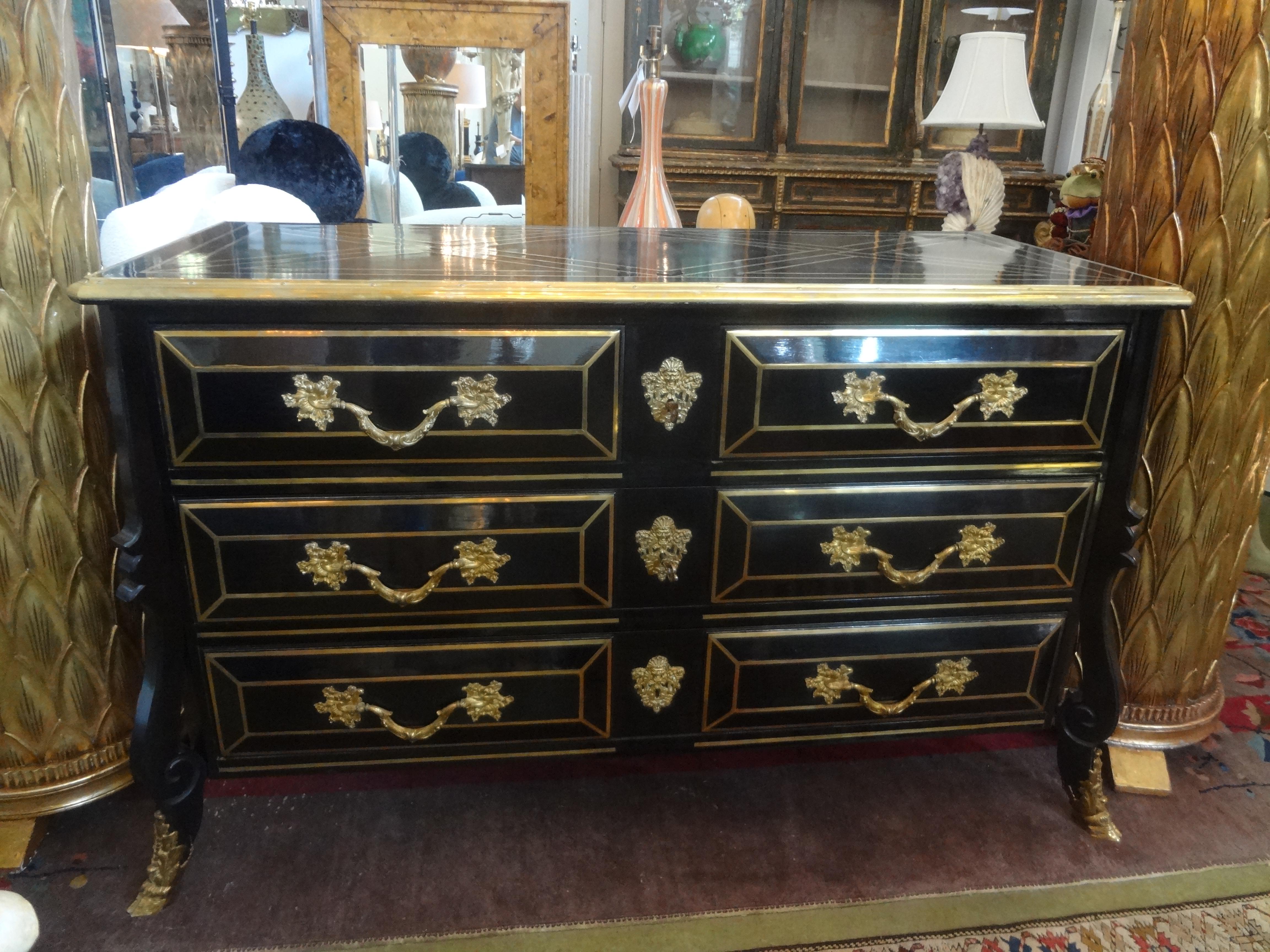 French Louis XV style lacquered commode, Maison Jansen attributed. 
This outstanding French black lacquer six drawer commode or chest is heavily inlaid and trimmed with gilt bronze in a geometric pattern with paw feet. This stunning expertly crafted