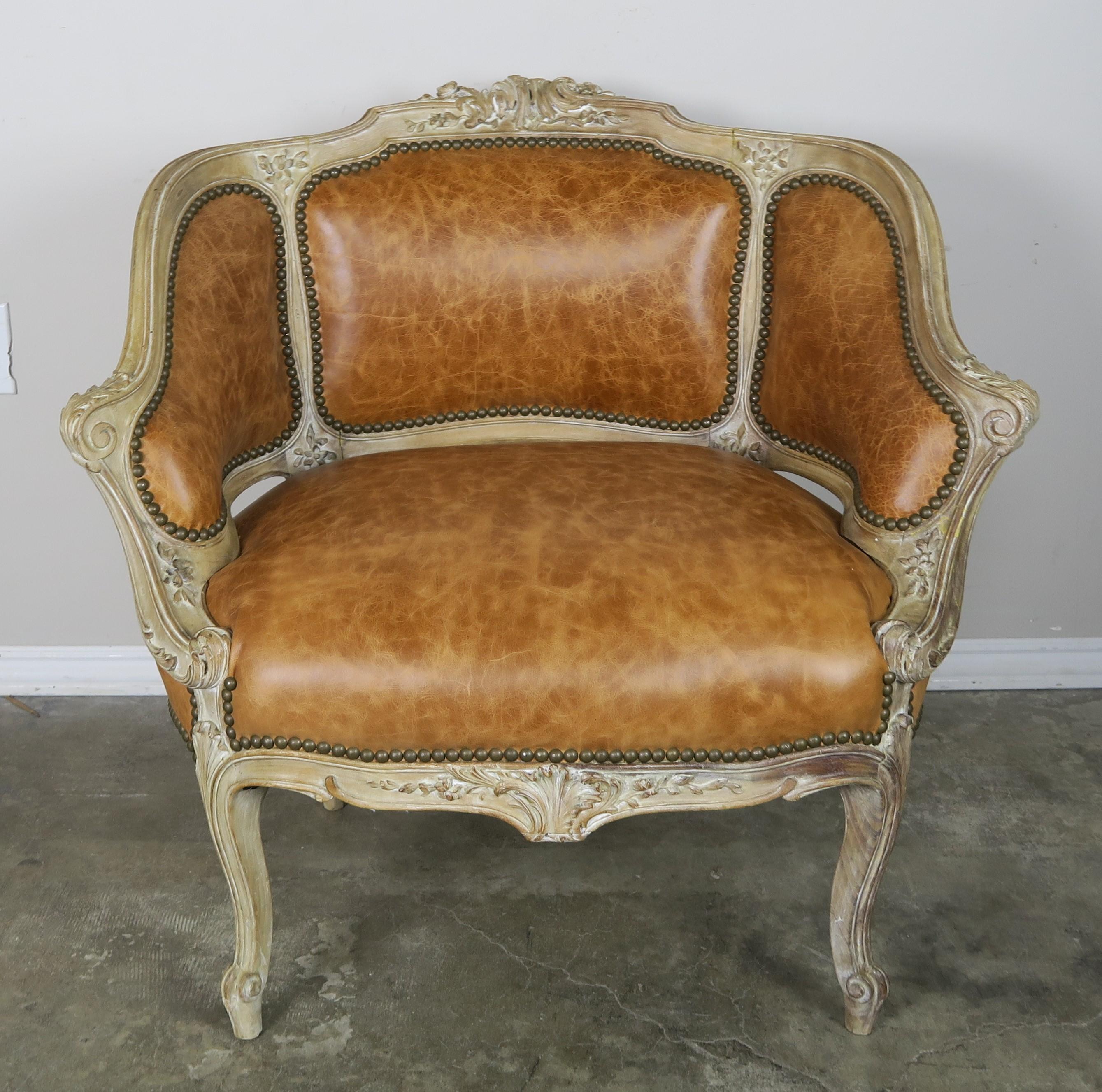 French Louis XV style painted armchairs upholstered in leather with nailhead trim detail. The beautiful armchairs stands on four cabriole legs that end in rams head feet. Beautiful weathered finish on the frame.
Measures: S.H. 16