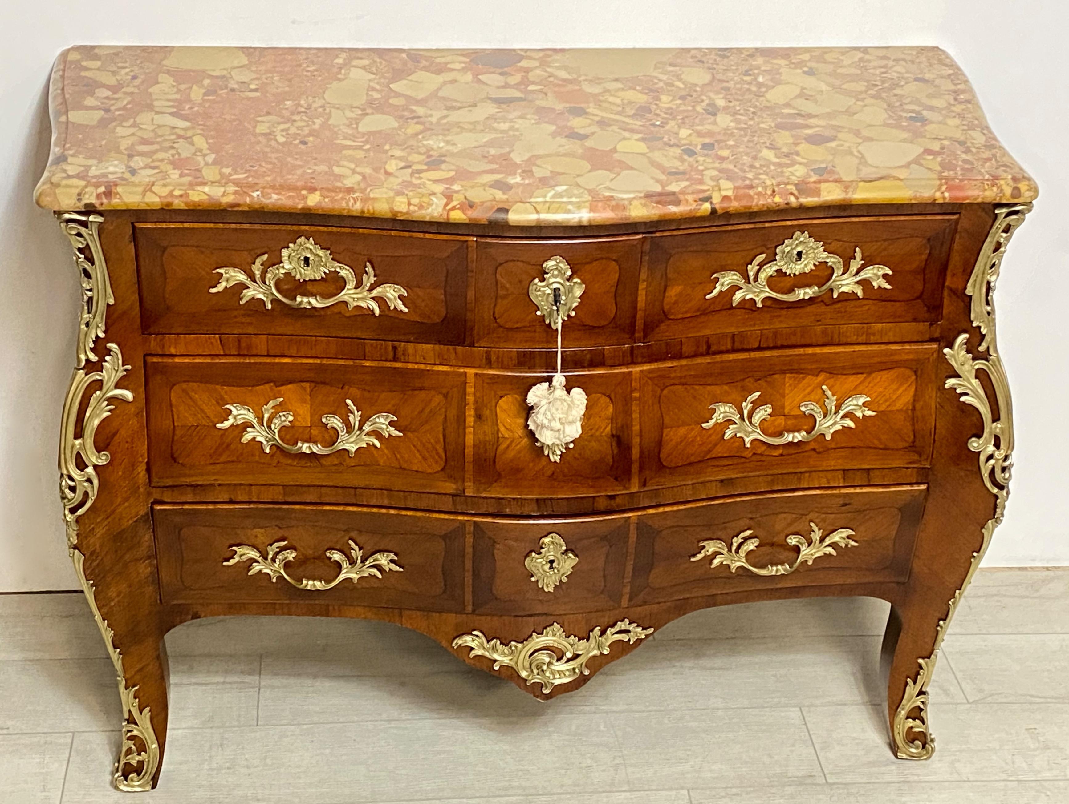 A large scale French Louis XV style three drawer mahogany bombe chest of drawers with inlay detail. The shapely front with original cast bronze mounts and original marble.
Exceptional quality and craftsmanship.
France 1st quarter 20th century