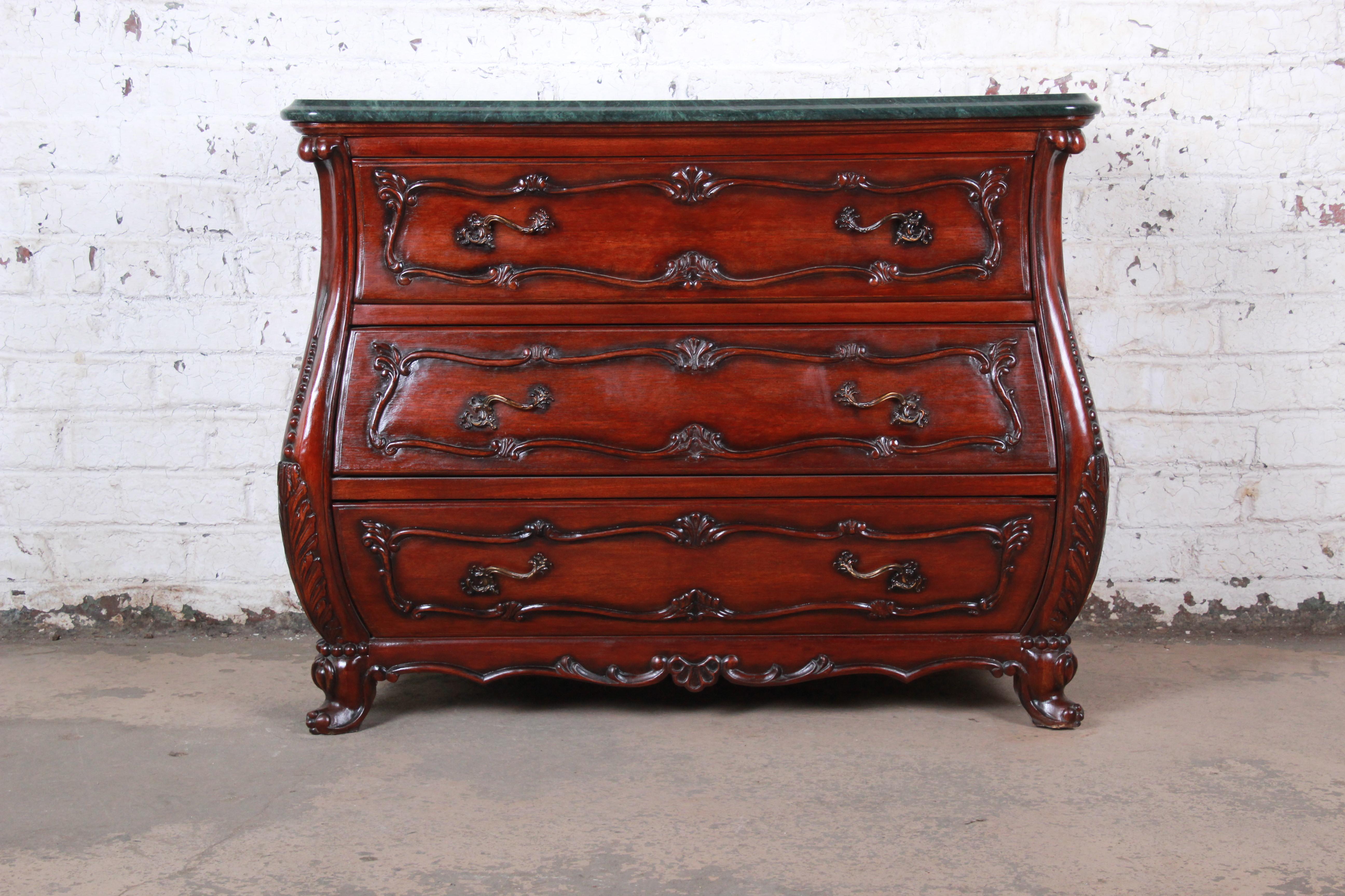 A gorgeous French Louis XV style carved mahogany marble top bachelor chest of commode

By IMA S.A.

Colombia, circa 1980s

Mahogany, beveled marble and brass hardware

Measures: 45.75