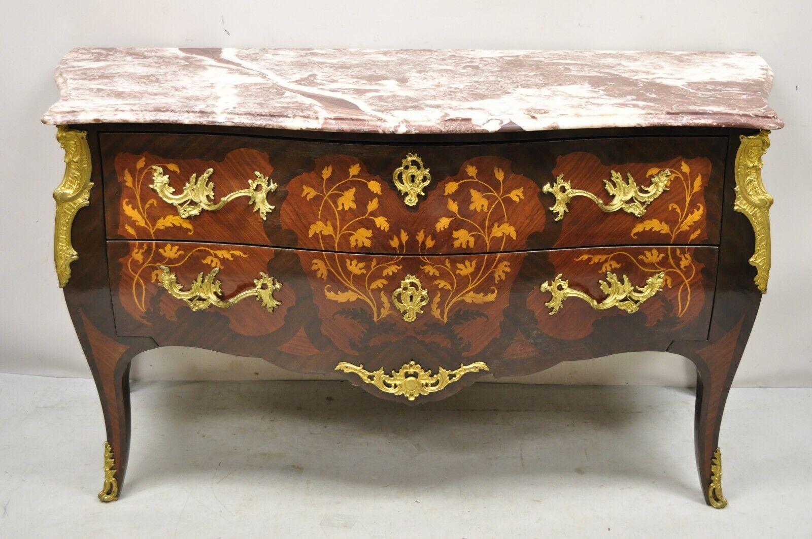 French Louis XV style marble top bombe commode dresser bronze ormolu. Item features ornate bronze ormolu, floral satinwood inlay, shapely bombe form, rouge marble top, beautiful wood grain, 2 drawers. Circa late 20th century. Measurements: 34