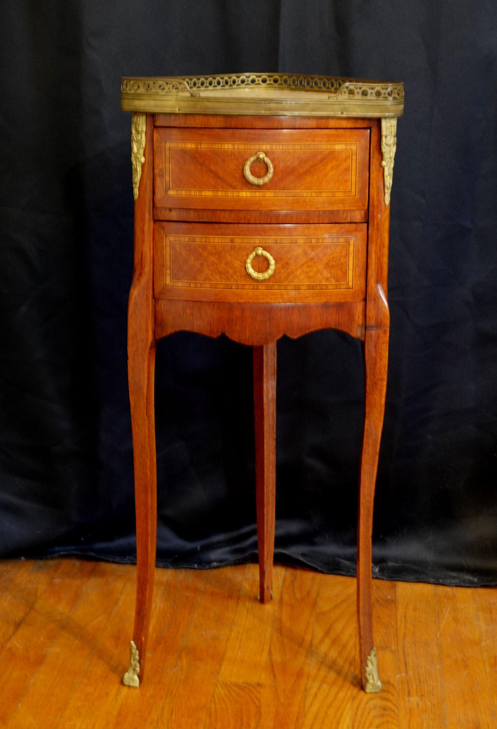 Louis XV style stand, having marble top with gallery over two inlaid drawers over three cabriole legs having brass mounts, height 29 1/2 inches.