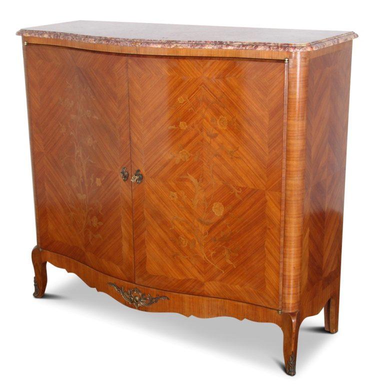 A French, Louis XV-style, two-door, marble-top cabinet in kingwood, with inlaid floral marquetry. The interior has three adjustable shelves and two small fitted drawers.



   