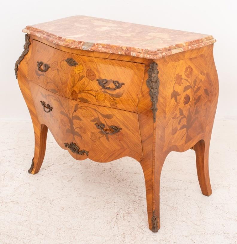 French Louis XV style rosewood marquetry commode or chest of drawers, with floral motif on the two curved drawers, raised on tapered legs, breccia pernice pink marble top, ormolu mounts. Measures: 32.5