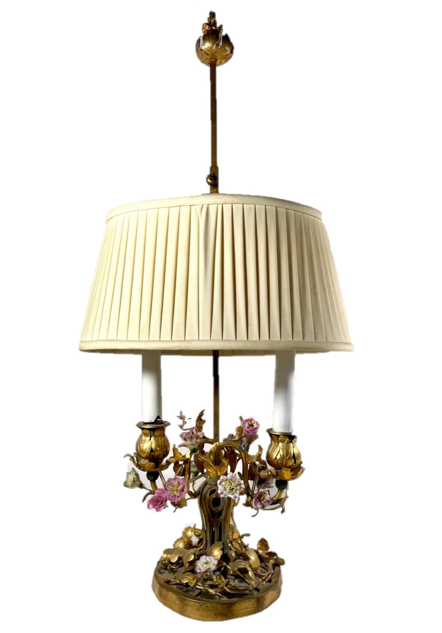 French Louis XV style ormolu mounted porcelain and tole two-light table lamp.

Antique 19th century ormolu and tole two-light table lamp decorated with Saxon 18th and 19th century porcelain flowers. This type of charming lamp is representative of