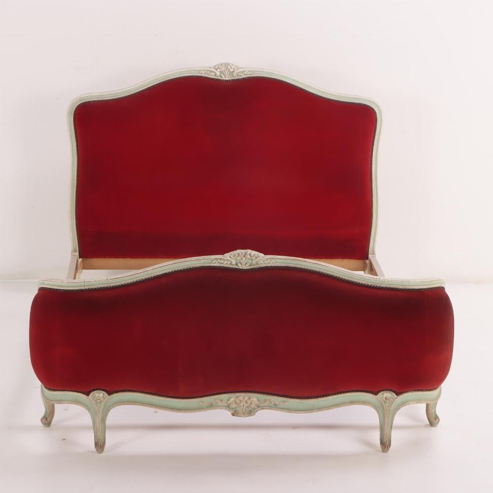 French Louis XV Style Painted Corbeille Bed with Red Upholstery C 1920. Fit for a regent, this bed frame has carved floral carved embellishments and luxurious red upholstery. Interior Dimensions 56