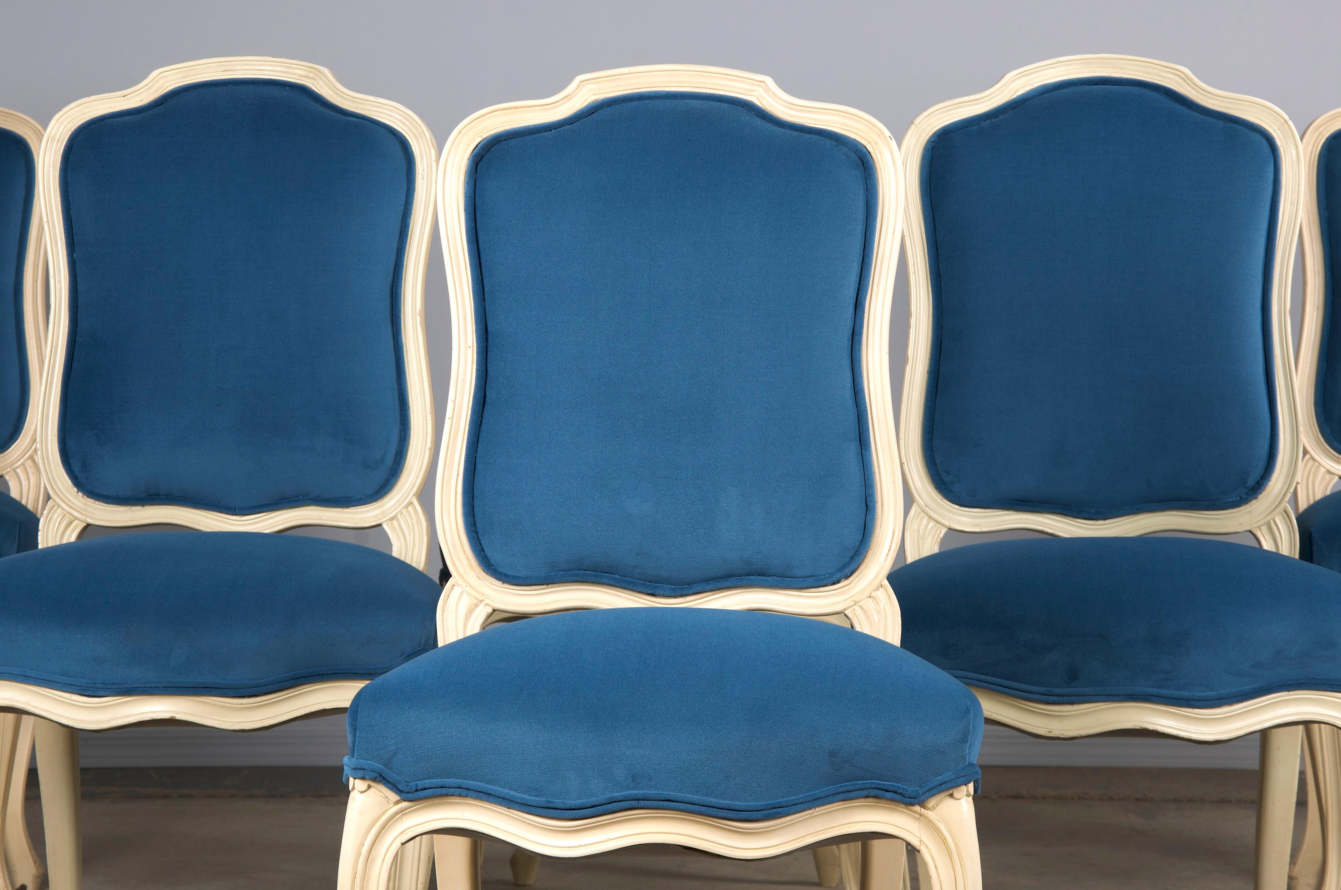 An elegant set of six French dining chairs made in the style of Louis XV sourced from Provence, France. Beautifully hand-crafted from solid wood finished in light creamy antique white paint showcasing a naturally aged patina with characterful