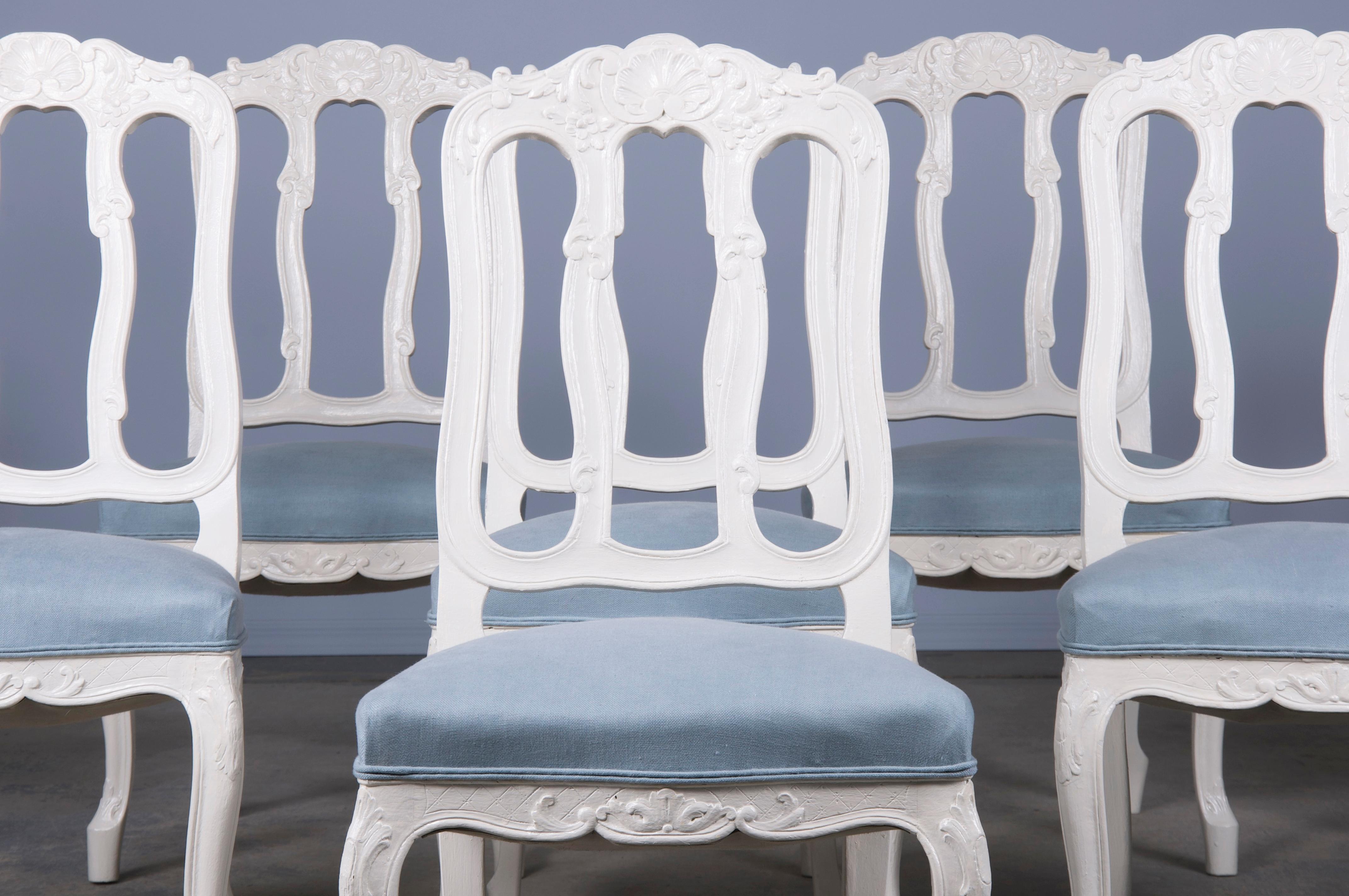 An elegant set of eight French provincial dining chairs made in the style of Louis XV, sourced from Provence, France. Each chair showcases a hand-crafted frame with slat backs. The chairs have been structurally restored, hand-painted with Benjamin
