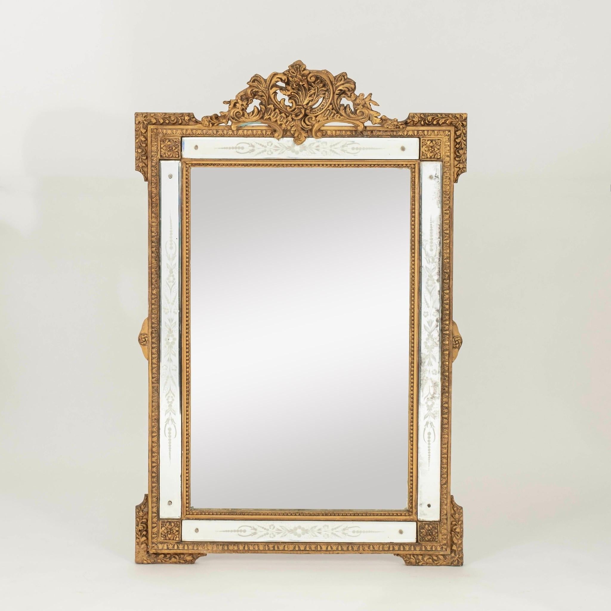 A 20th Century or earlier Louis XV style parclose giltwood mirror with etched floral and foliage detail.
